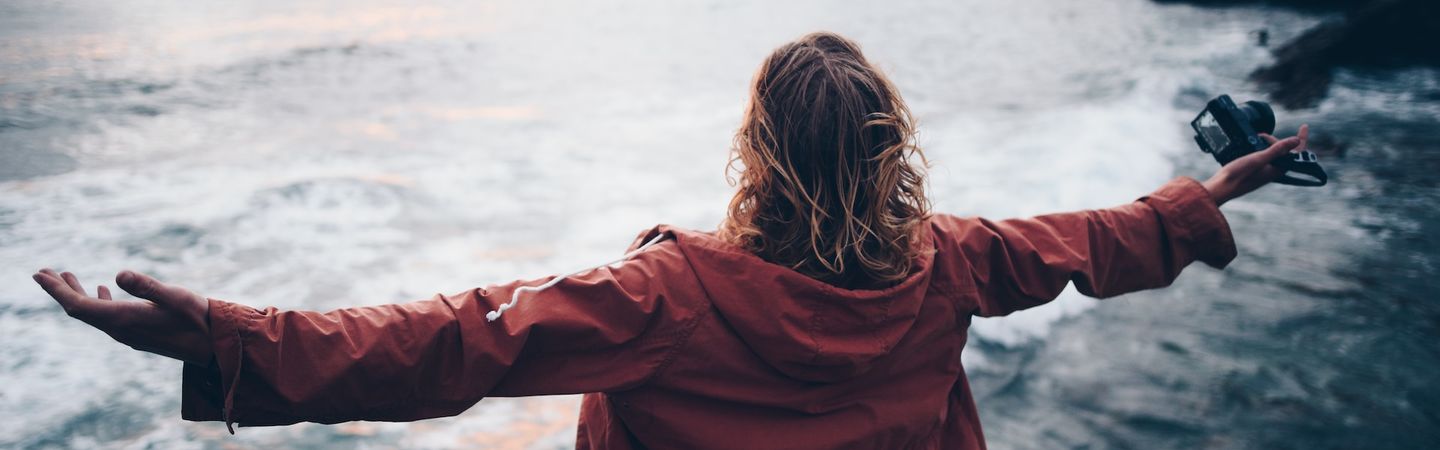 five hands of different colours sit palms down on a wooden table | five reasons self care does not work in healthcare | Tempo Therapy and Consulting