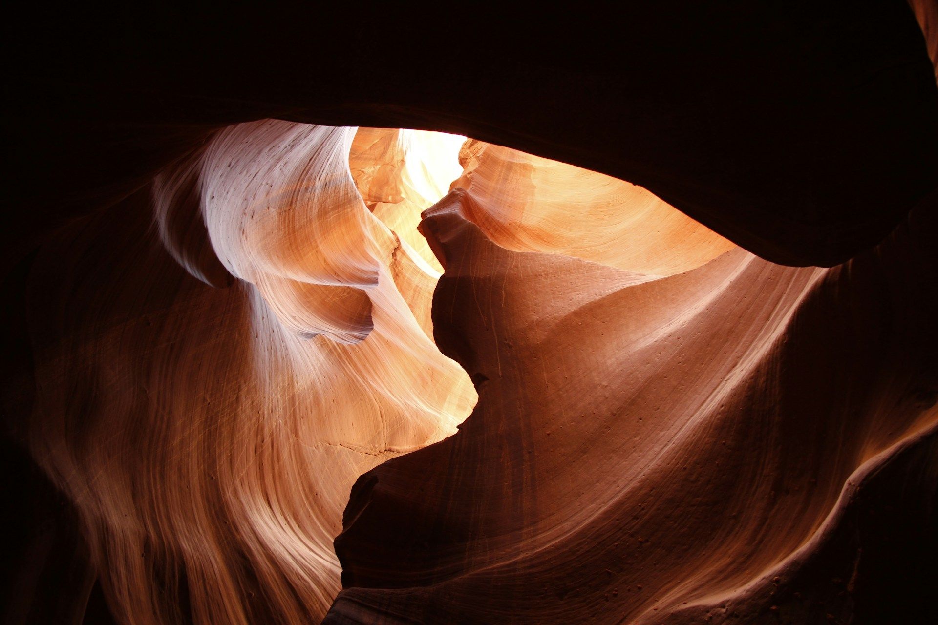 sunlight shines into dark orange carved rock of an underground cave | Tempo Therapy and Consulting |  hope in healthcare