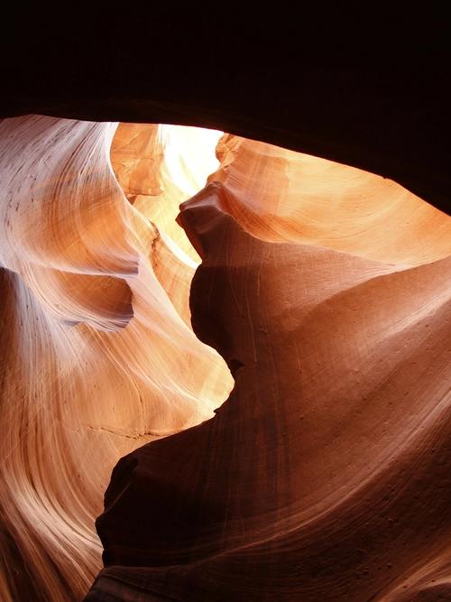 sunlight shines into dark orange carved rock of an underground cave | Tempo Therapy and Consulting | hope in healthcare