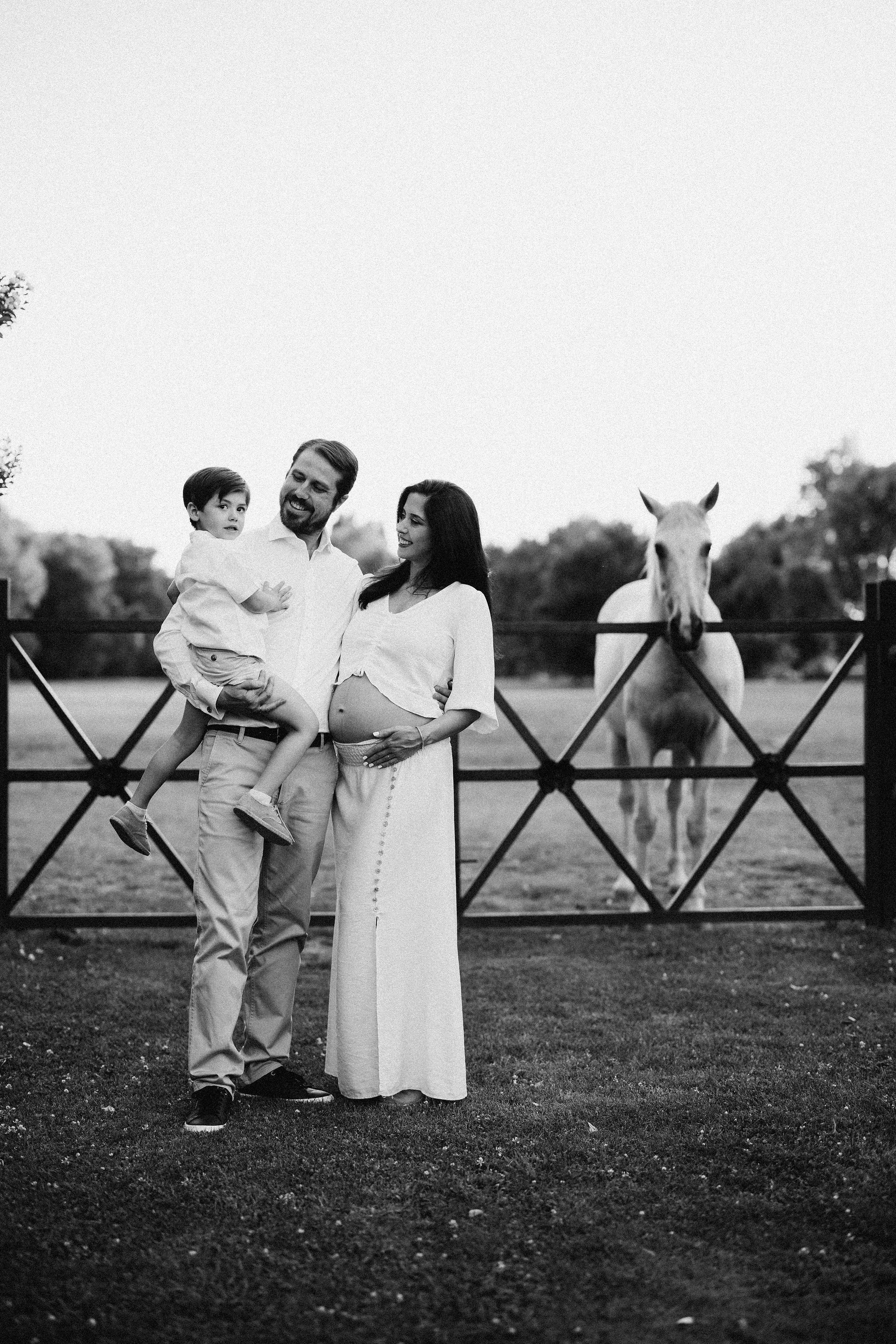 Mum-to-be with her son in a garden, black and white