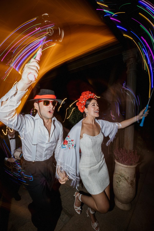The newlyweds leap through coloured lights during the party hour