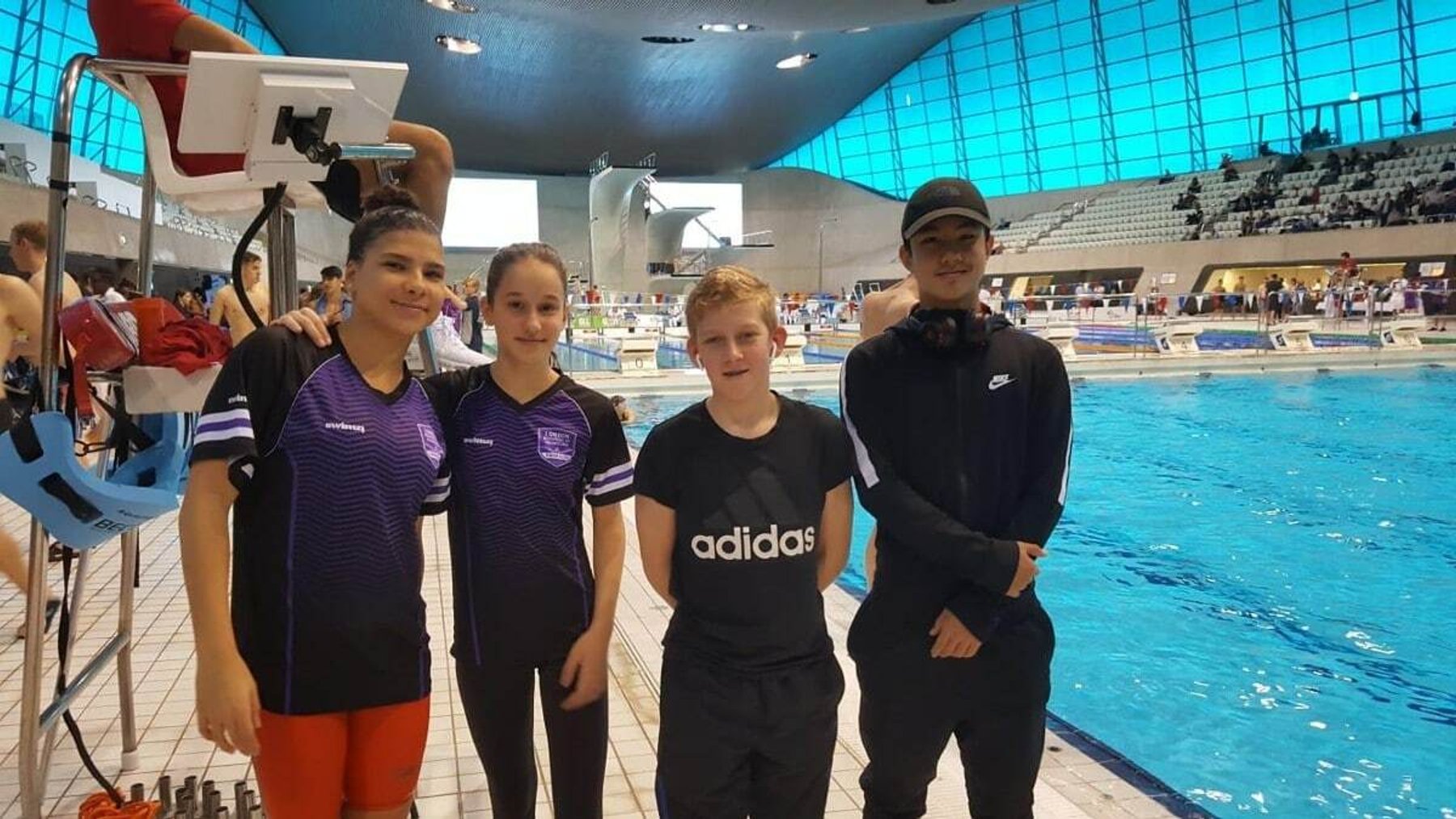LBHSC swimmers and their coach poolside at the London Aquatics Centre