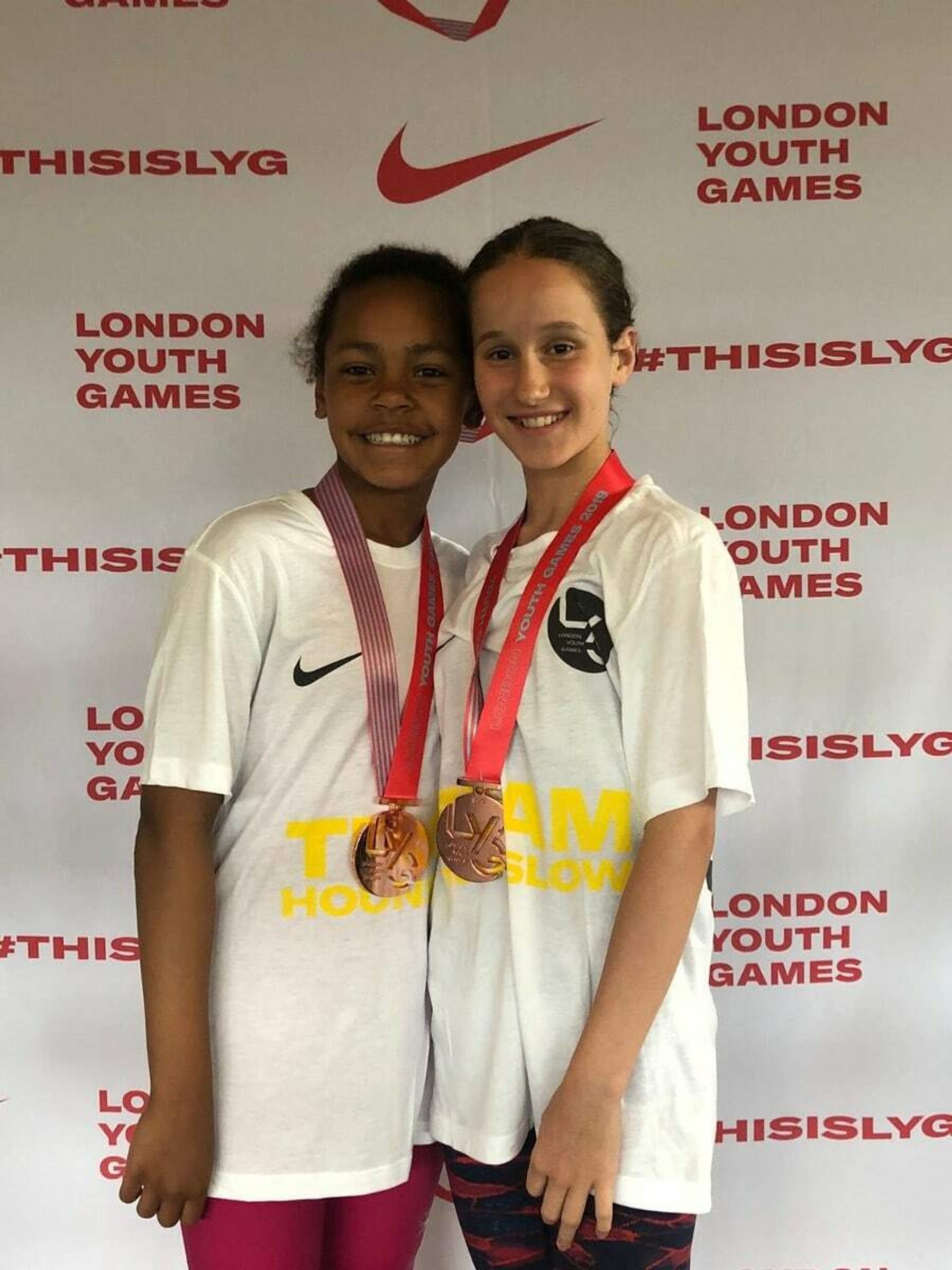 Two LBHSC swimmers wearing their medals at the London Youth Games