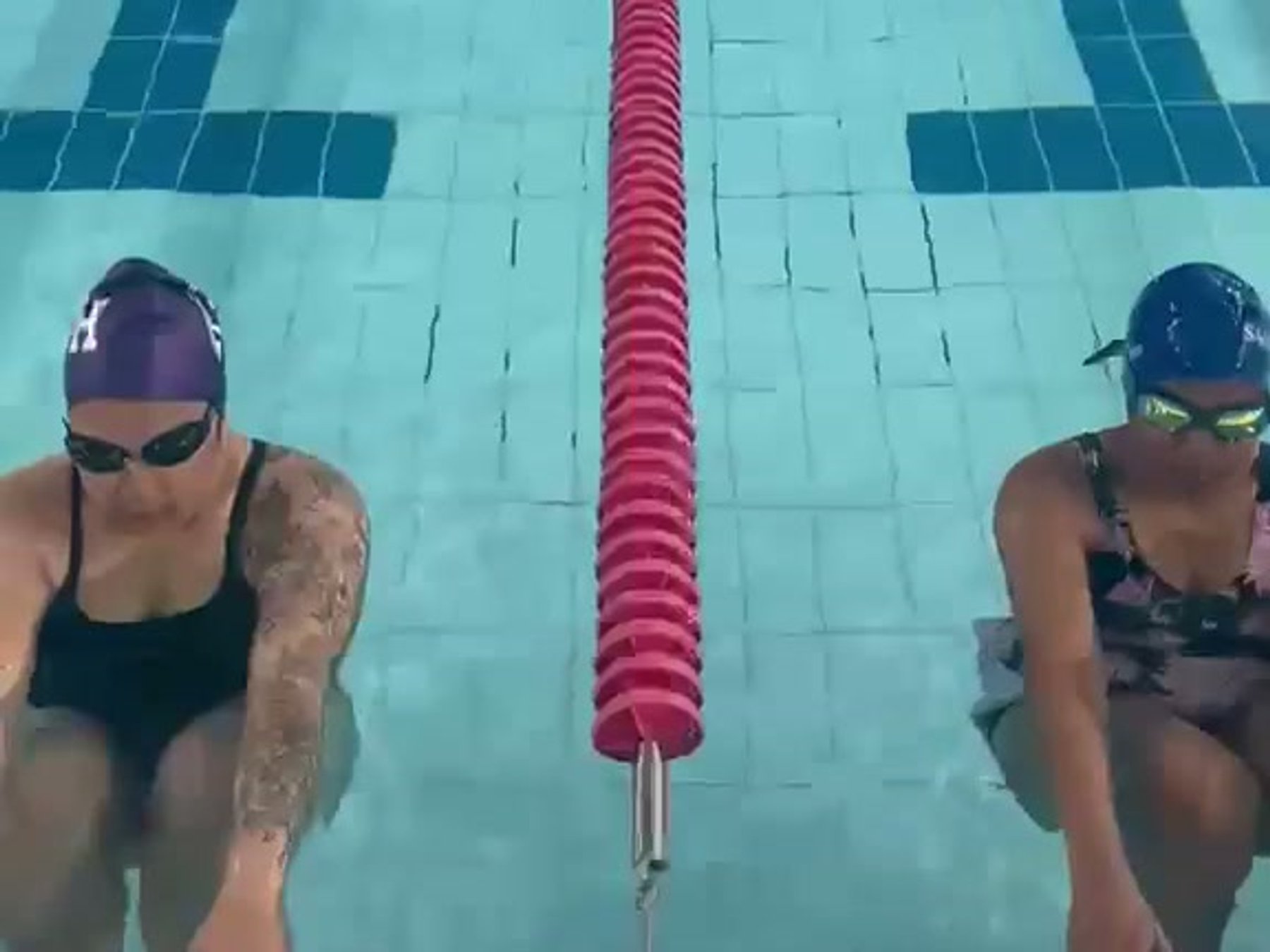Two adult swimmers ready at the wall