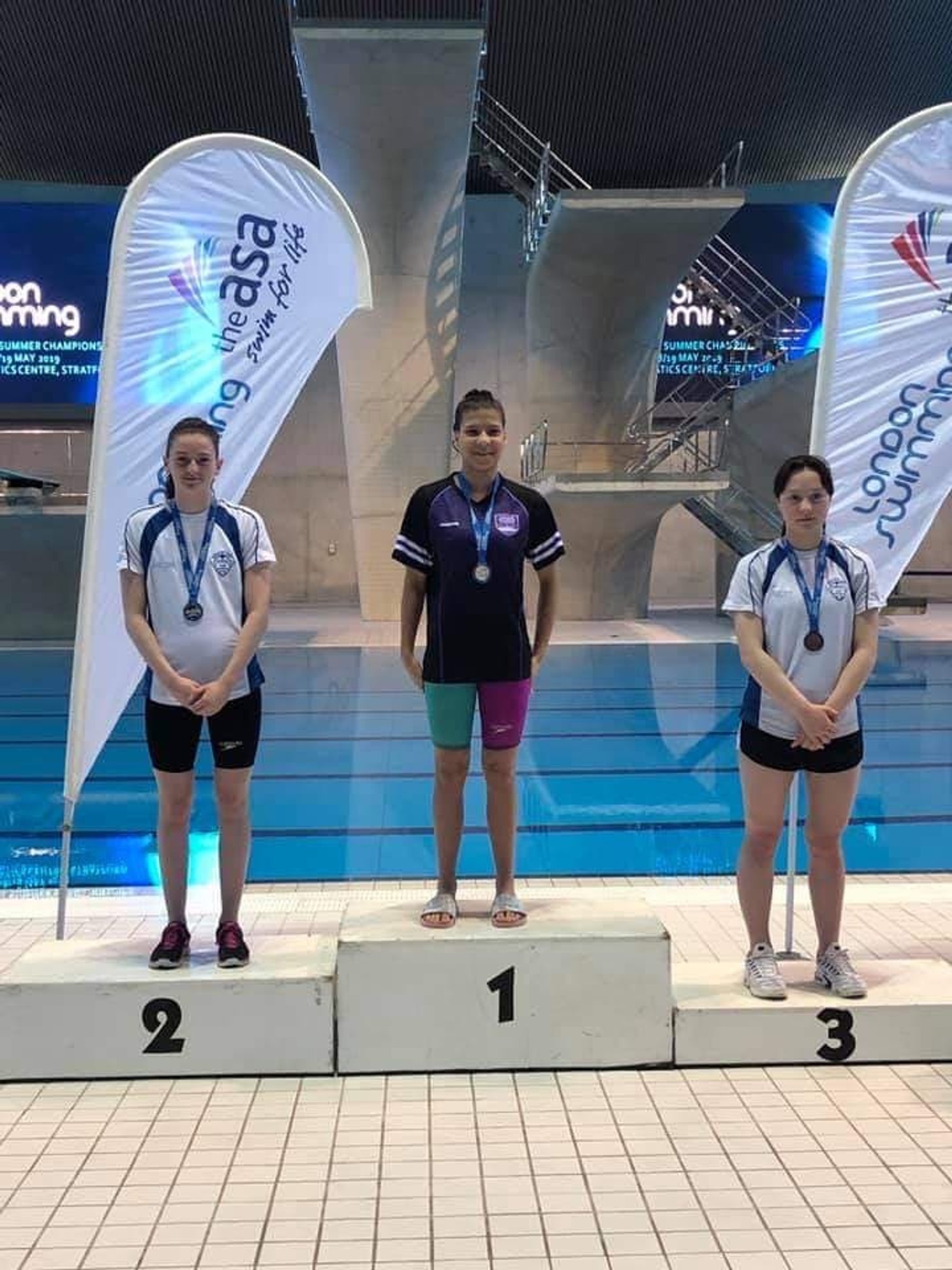 LBHSC swimmers on the podium at a gala