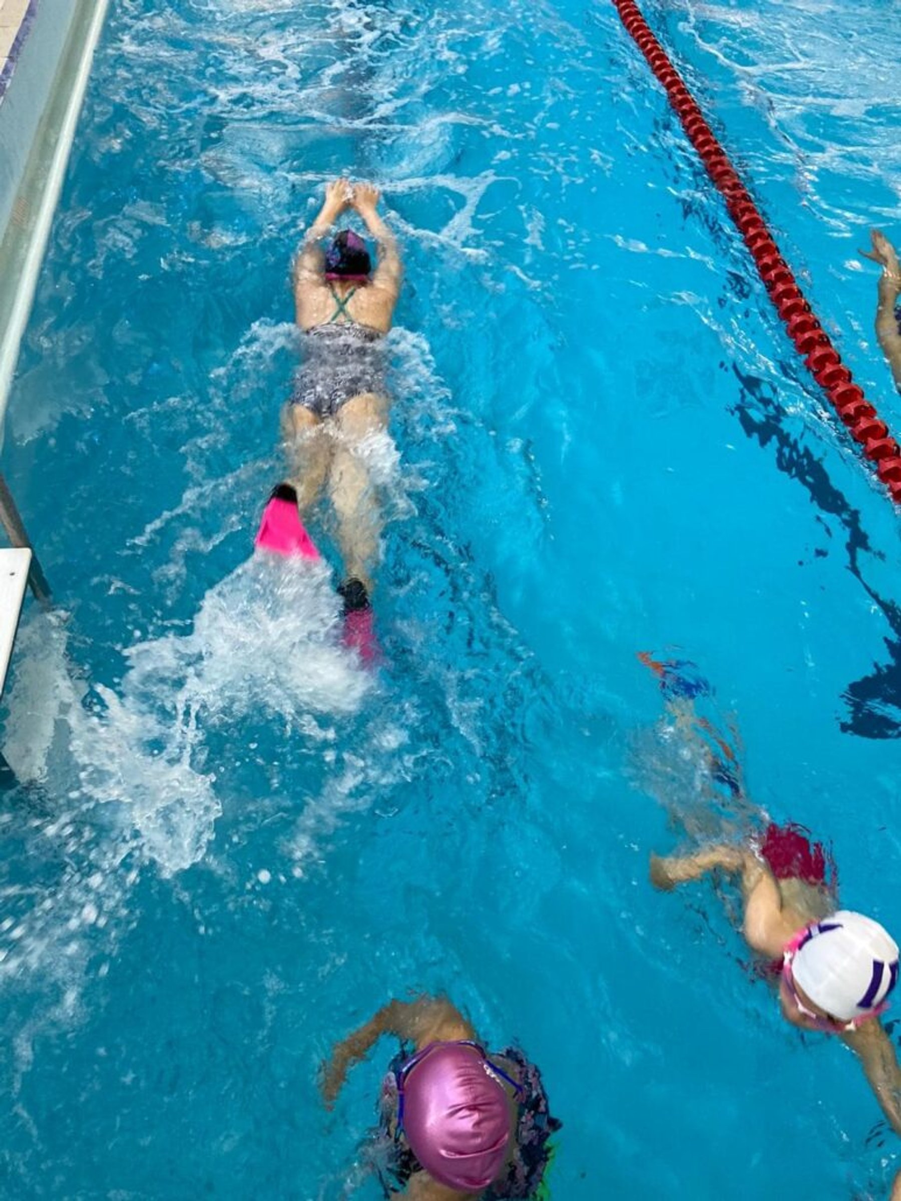 A squad swimmer practising backstroke in training