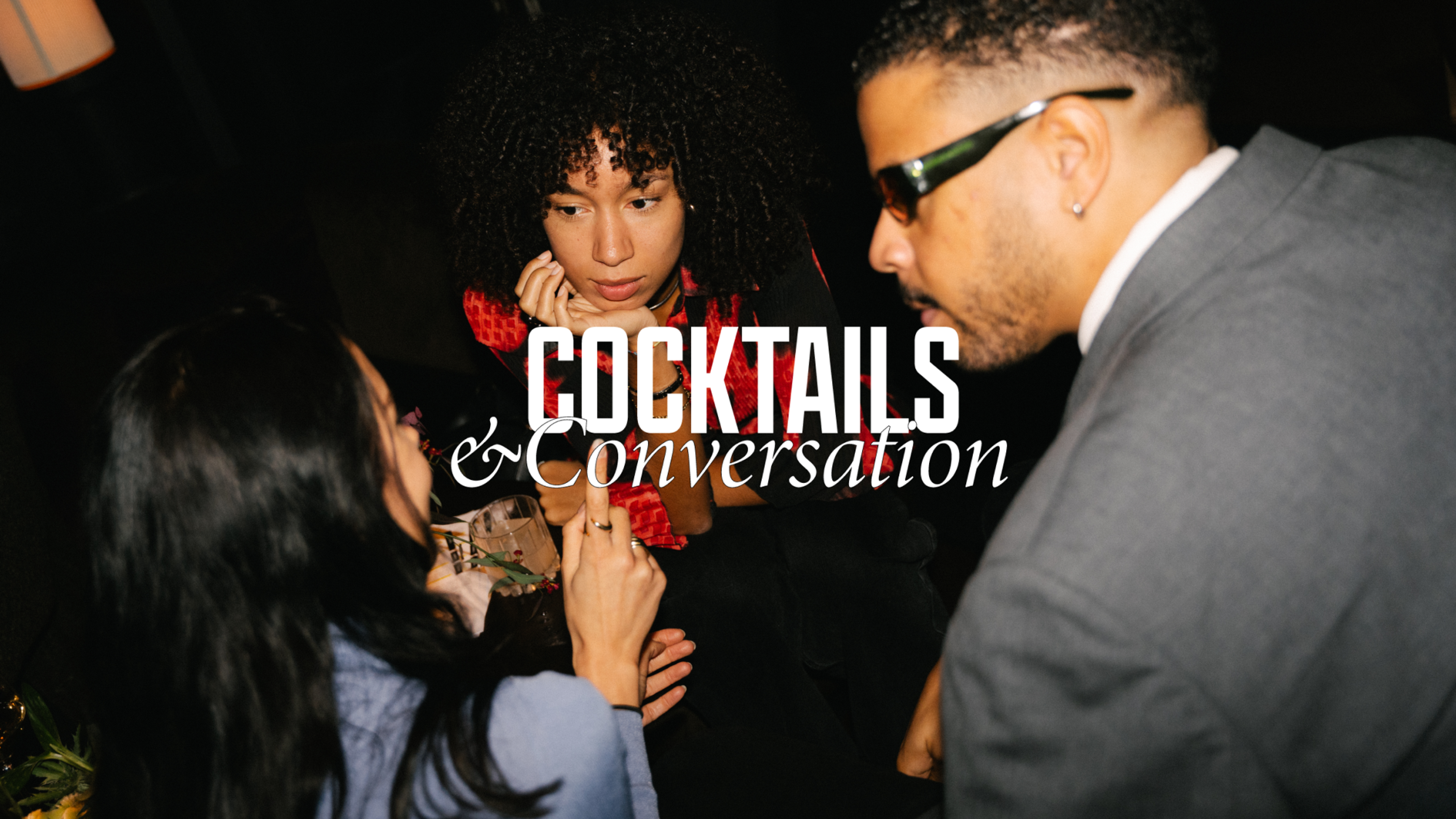 Three people having conversation in a bar.