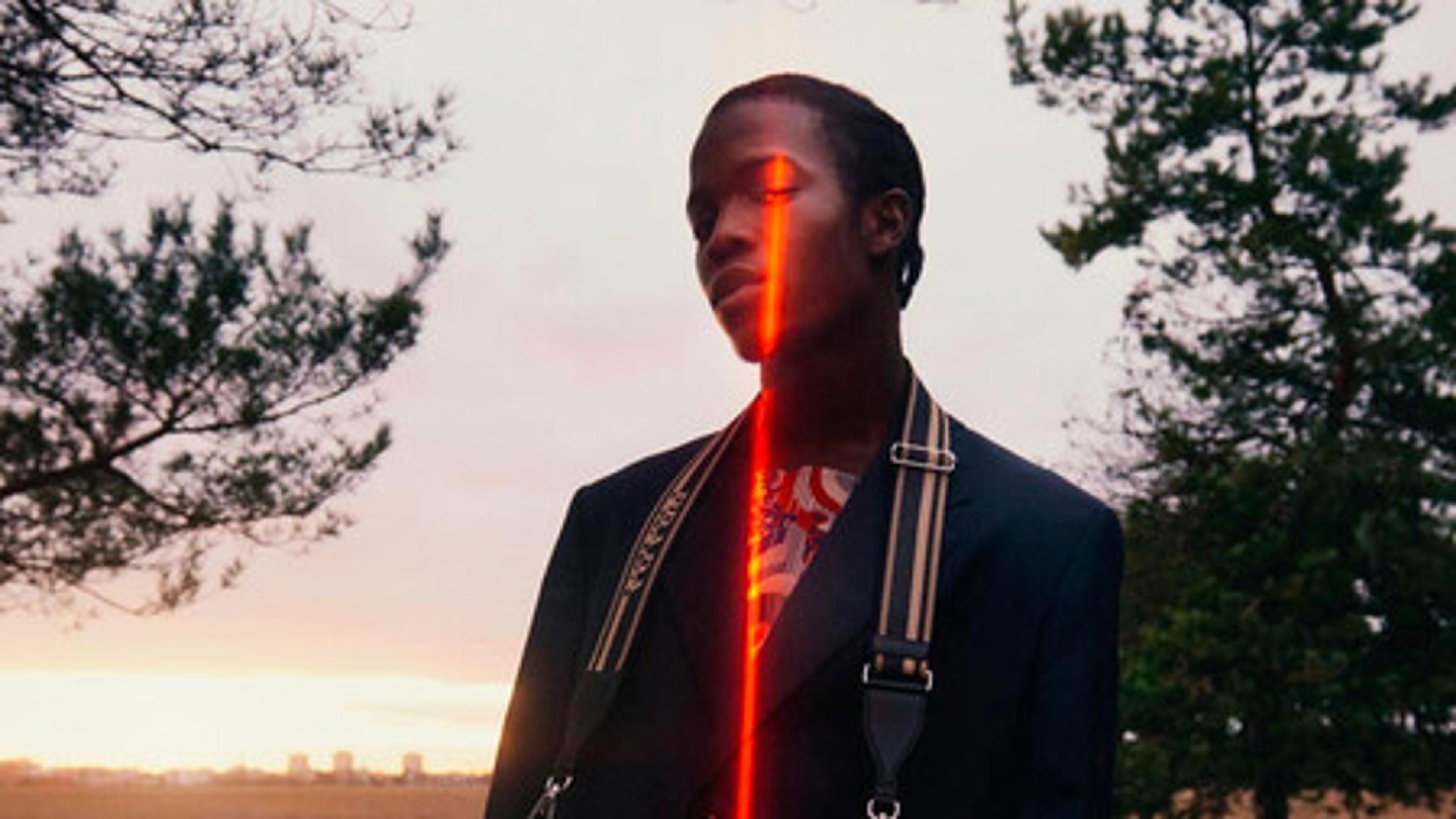 Man with a red streak of light across his face.