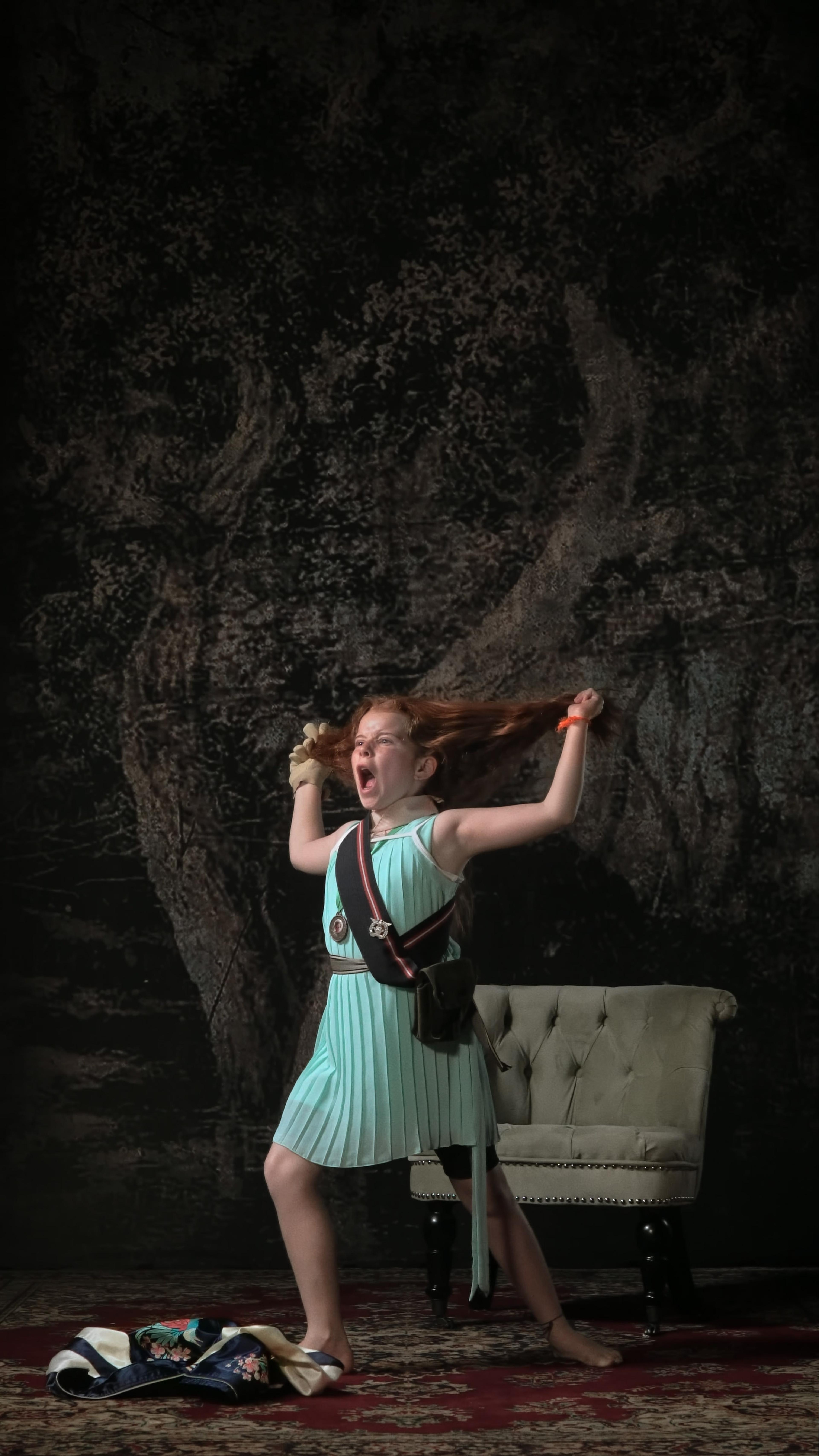 Girl with red hair shouting.
