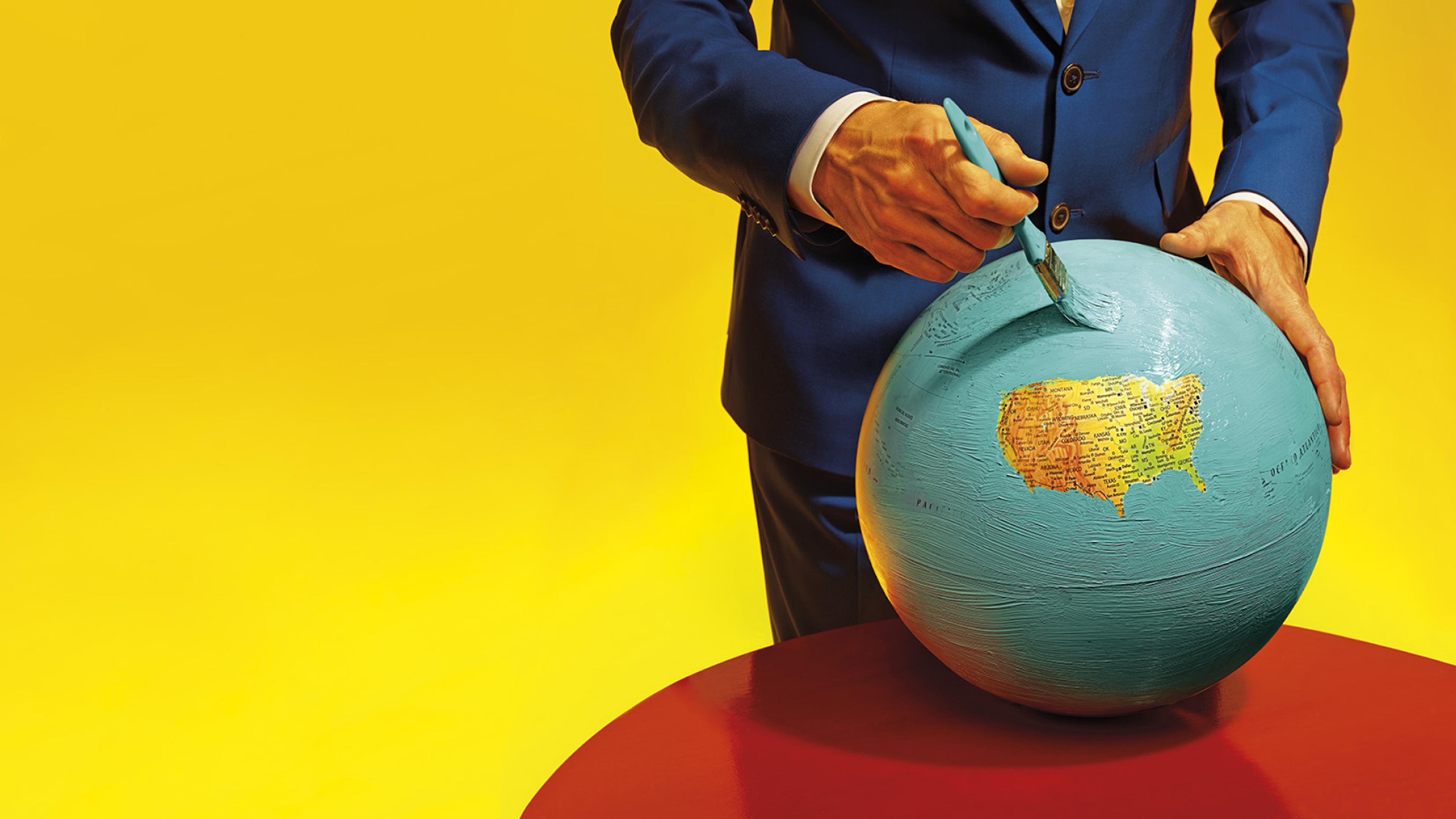 an image of a person in a suit painting a globe blue