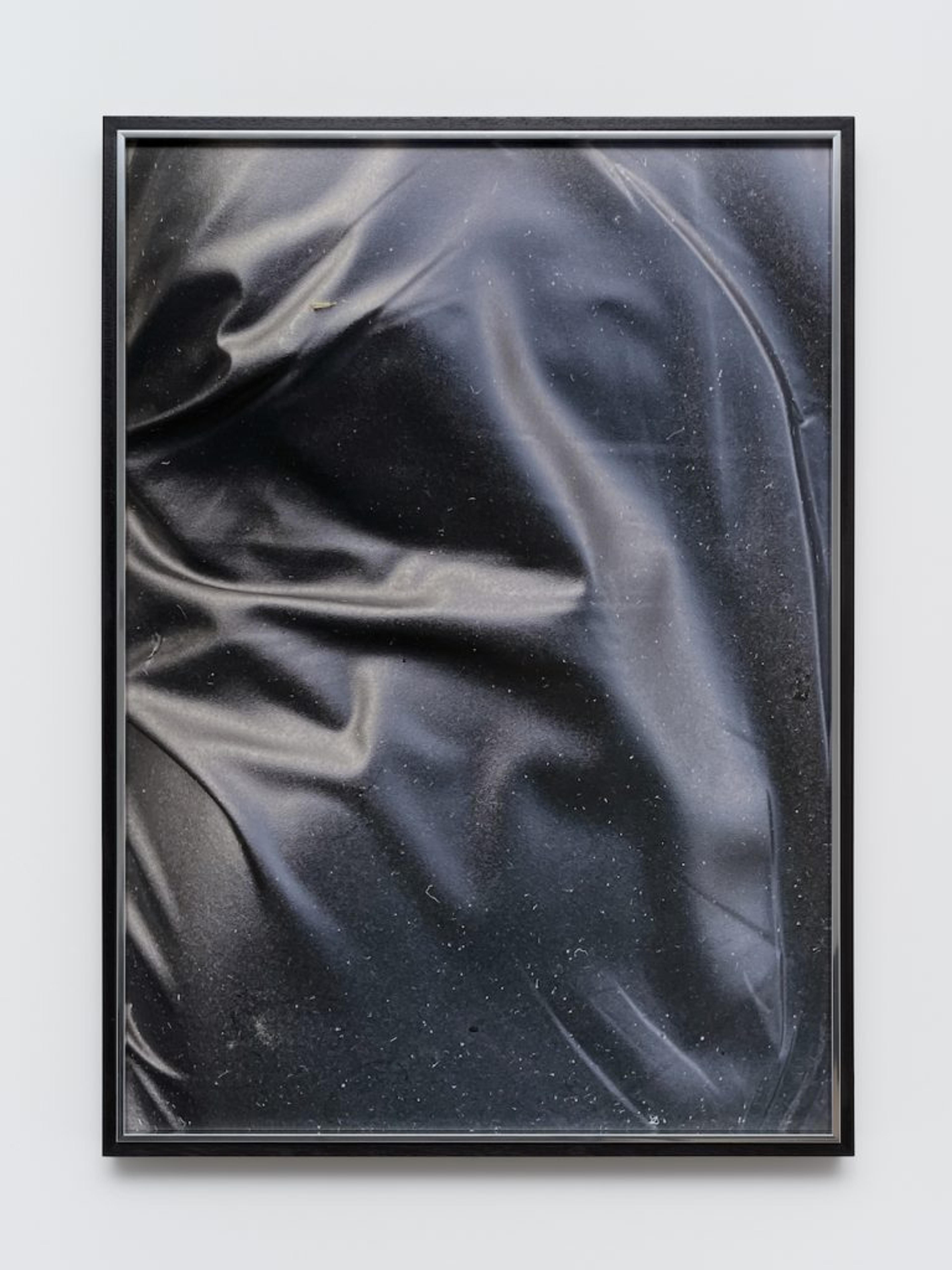 A monochrome image of a black fabric, showcasing its texture and contrast.