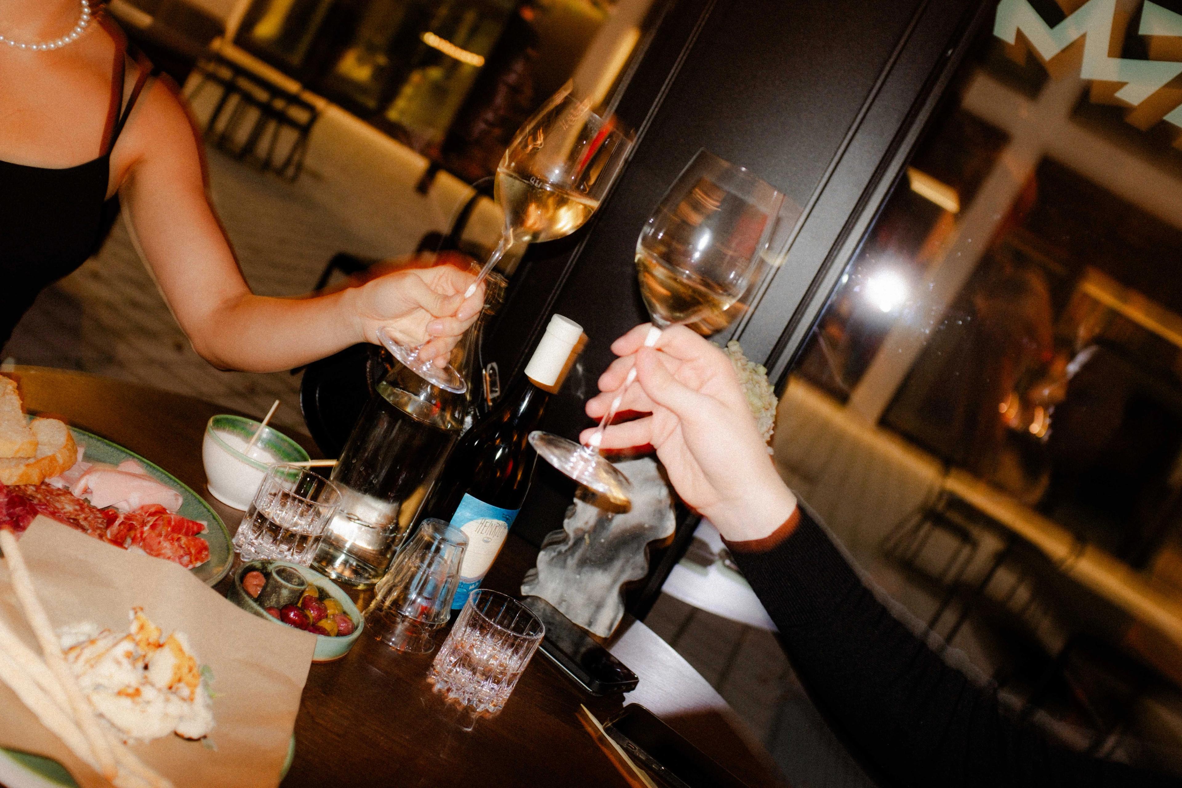 Two wine glasses in hand