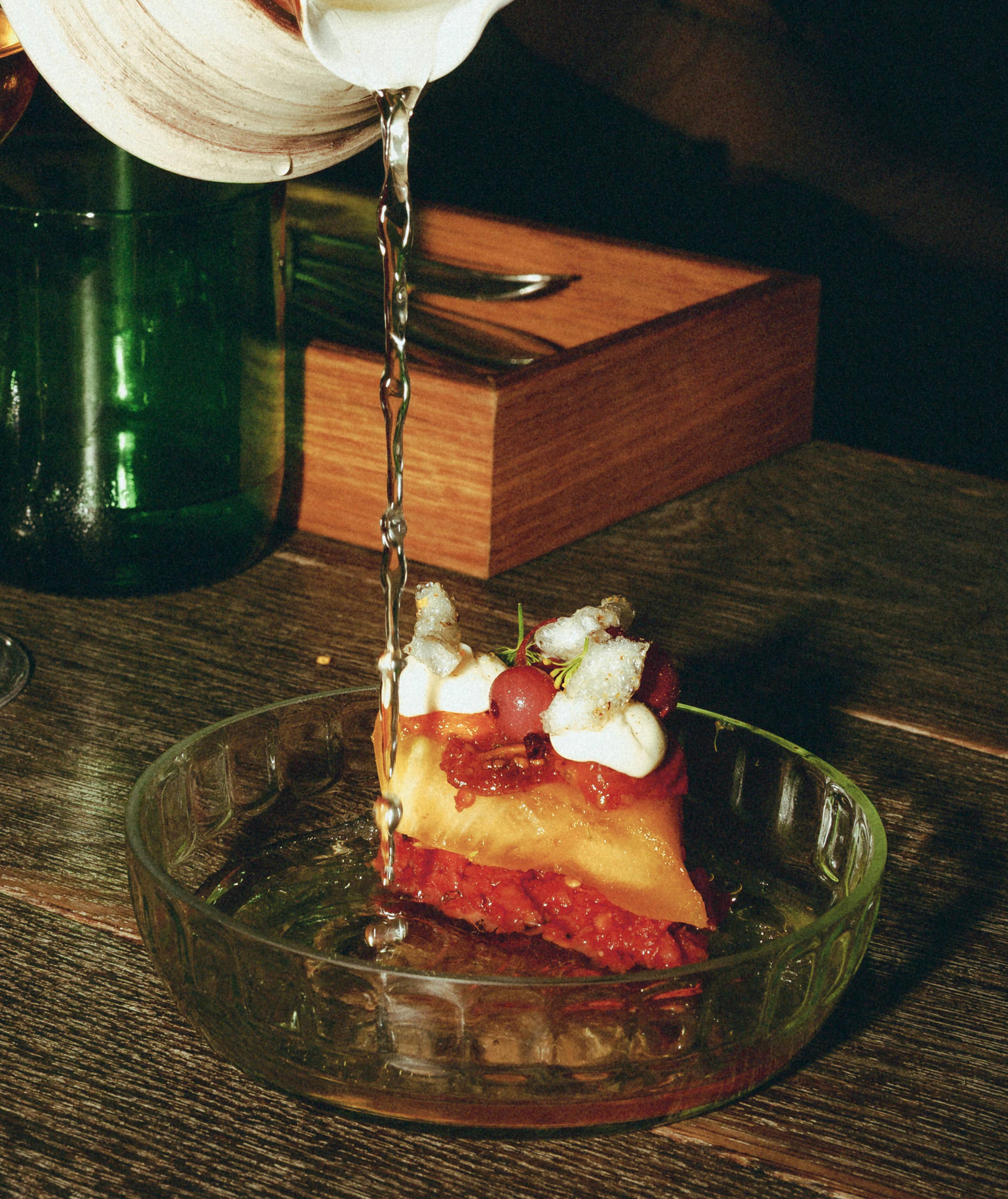 Plate with fine dining food on wooden table