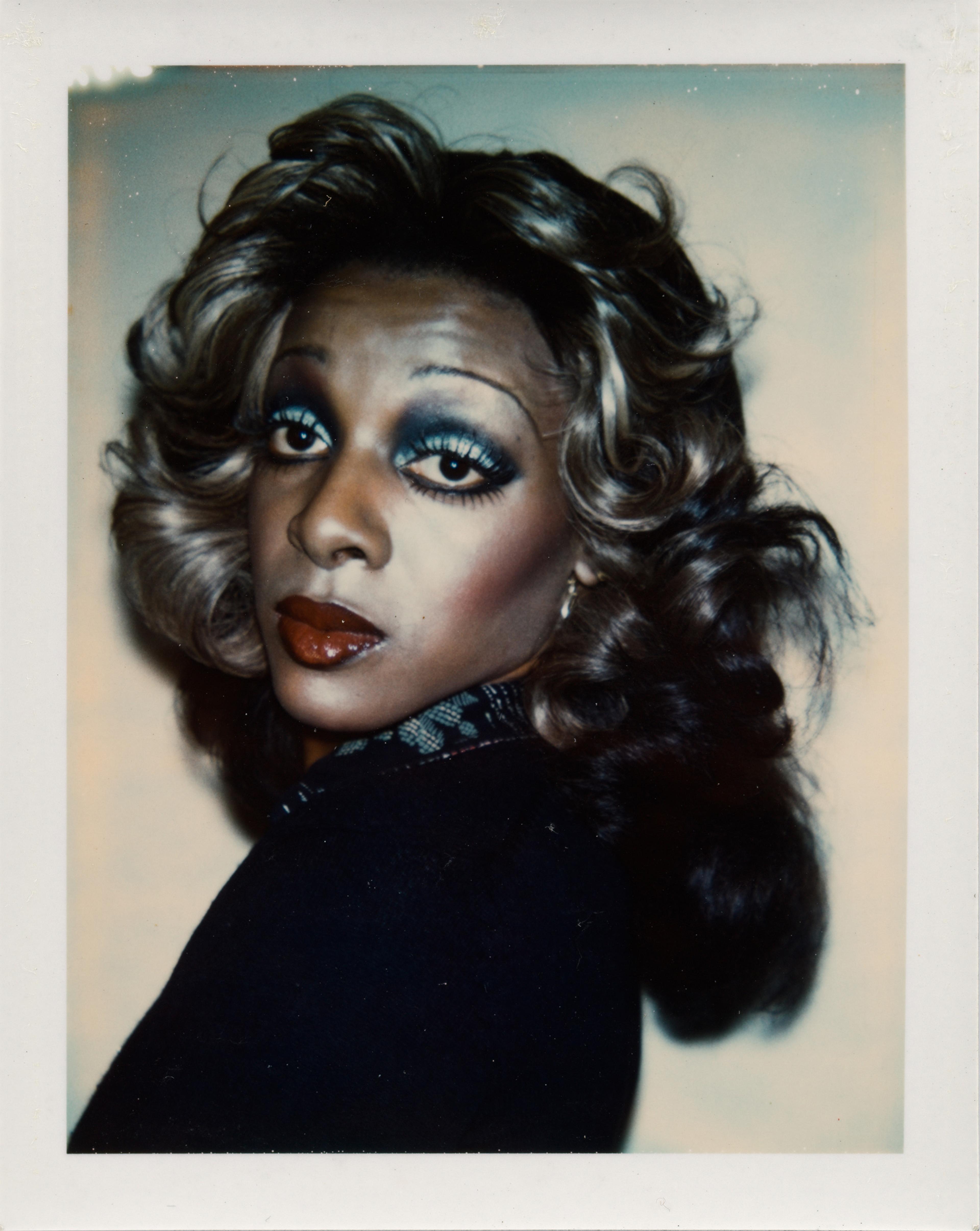 Polaroid of a person with a lot of make-up.