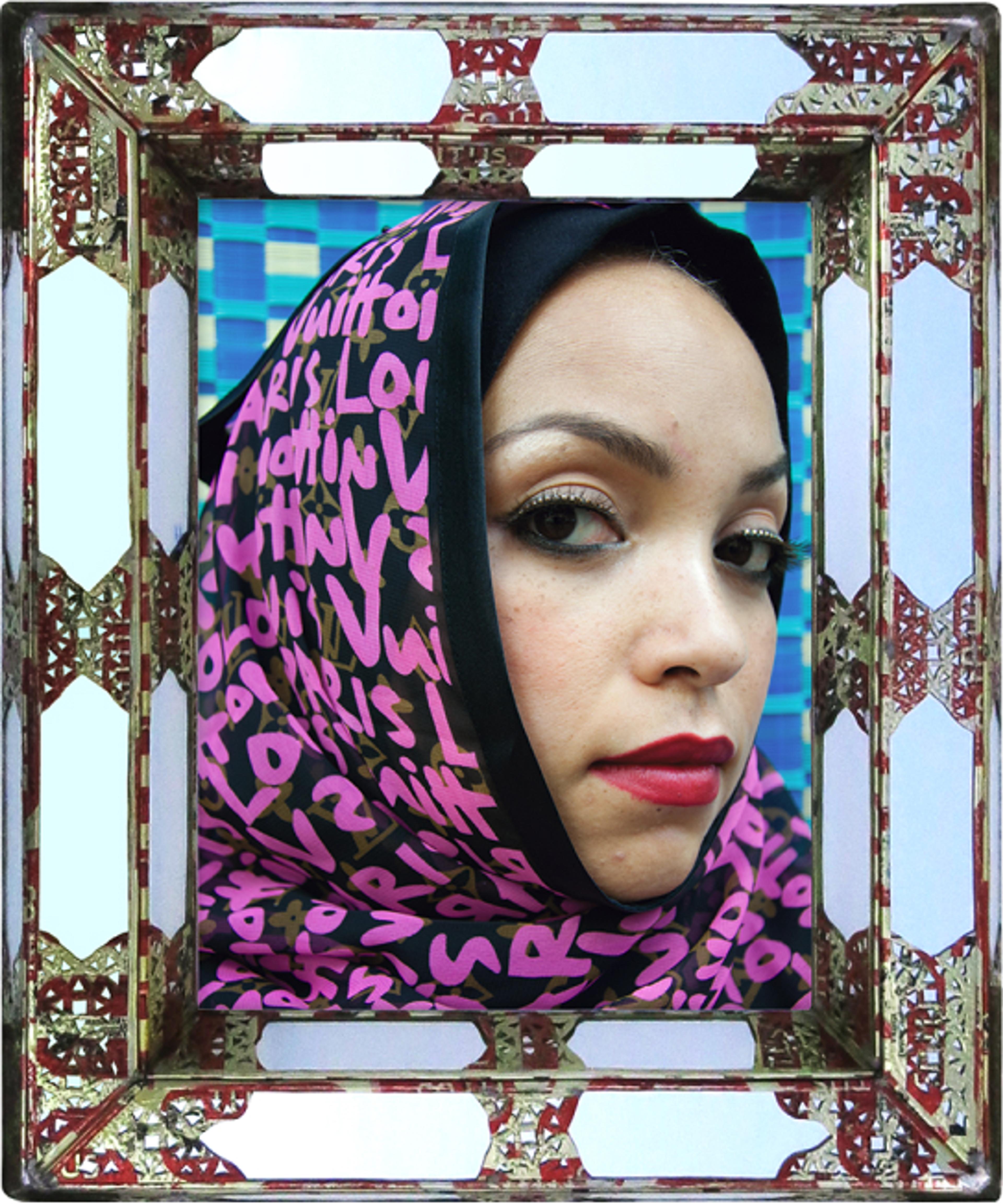 Close-up portrait of a woman wearing a black-and-pink Louis Vuitton hijab