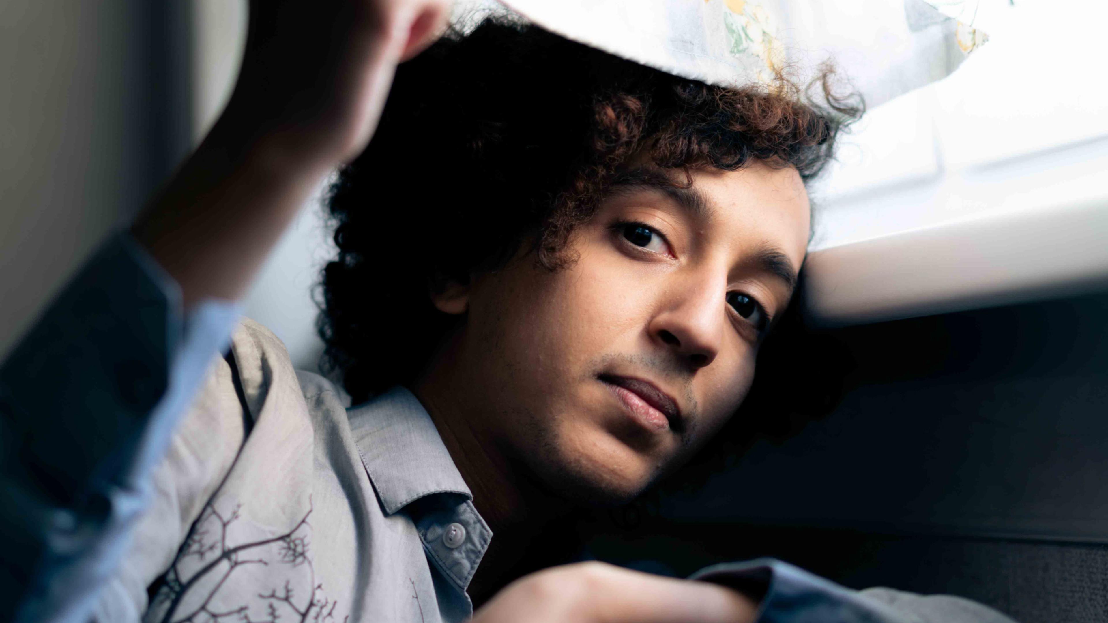 Portrait of a young man next to a window