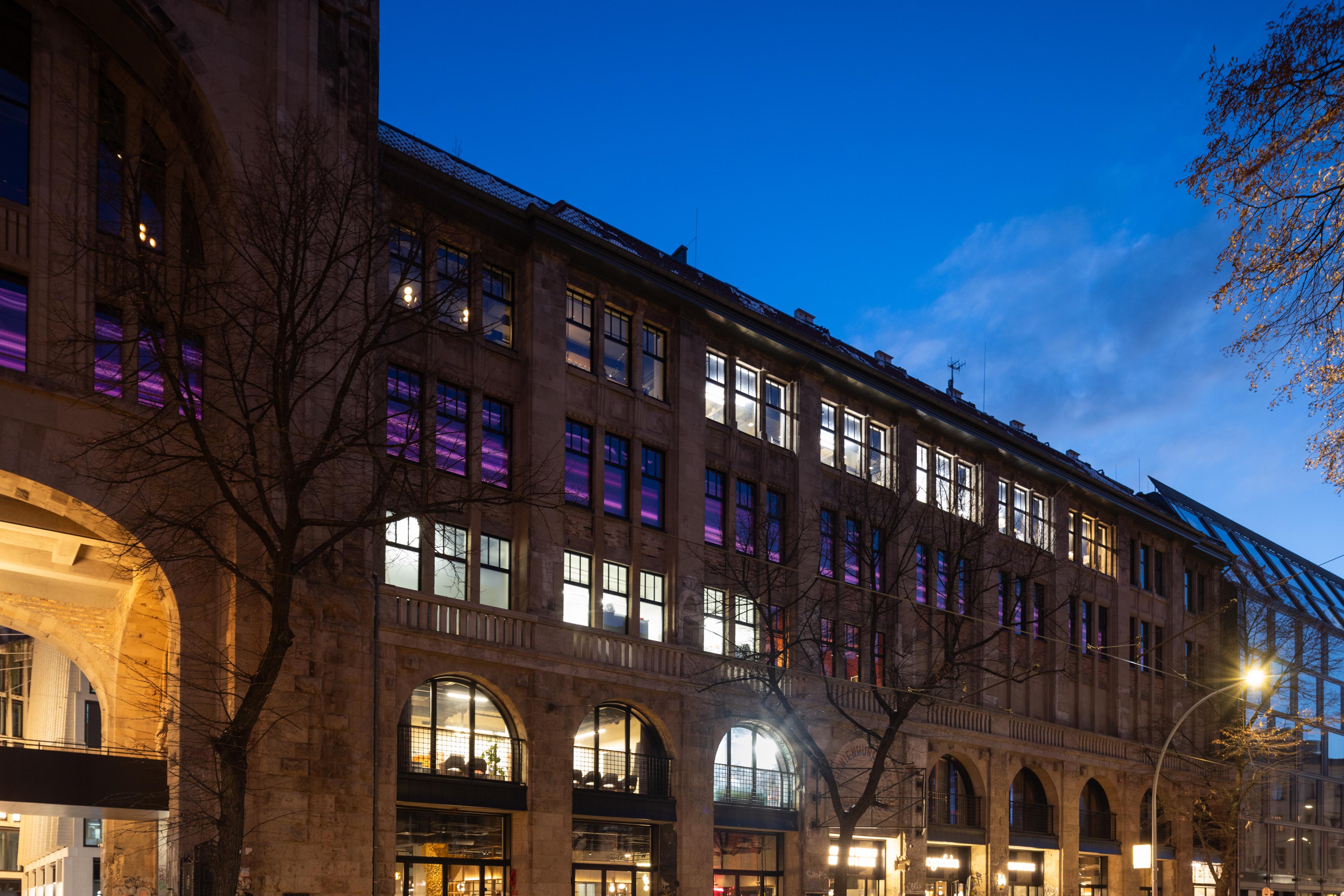 building facade lighting up with sceens in purple