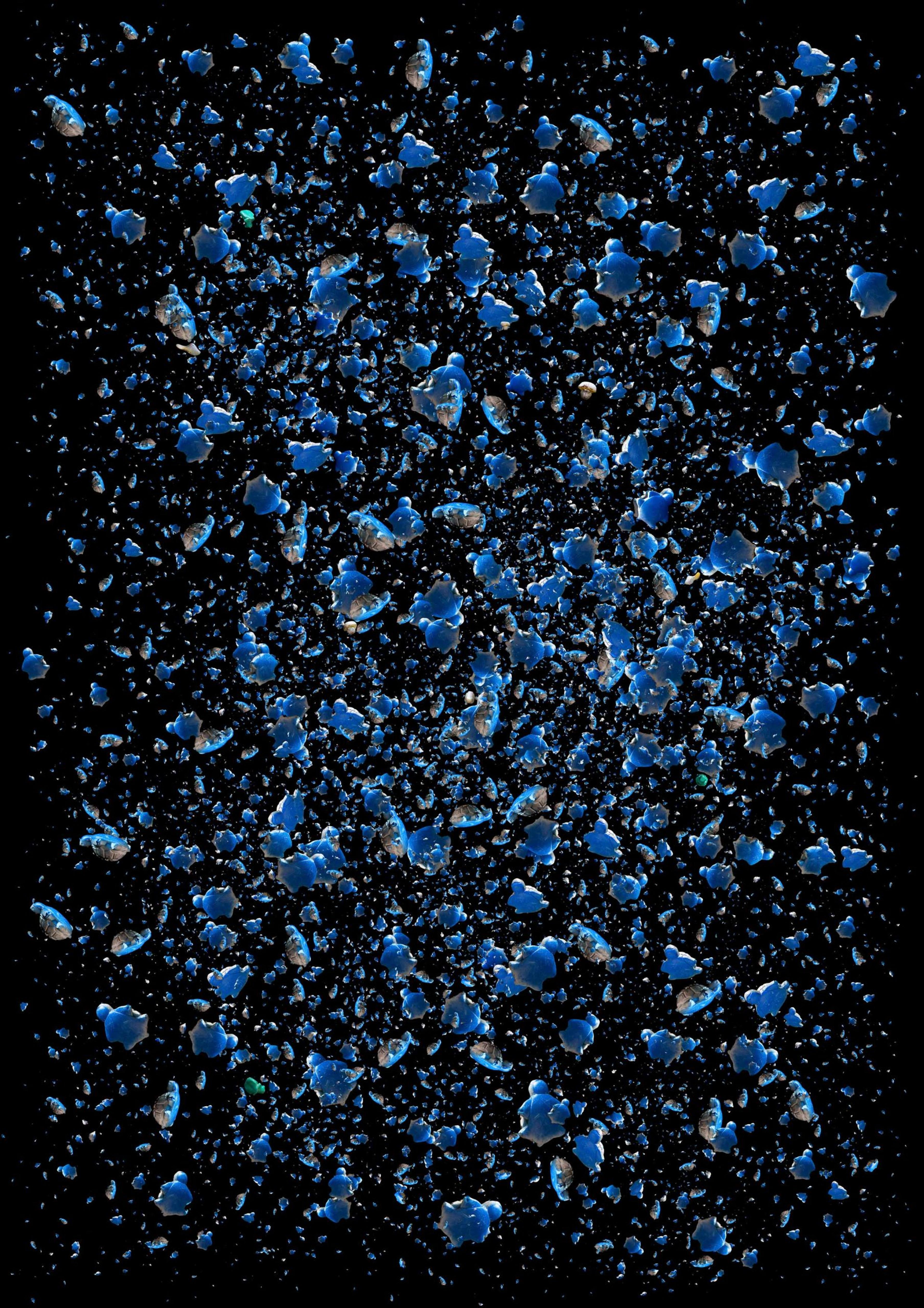 Blue shards of platstic spread out on a black background