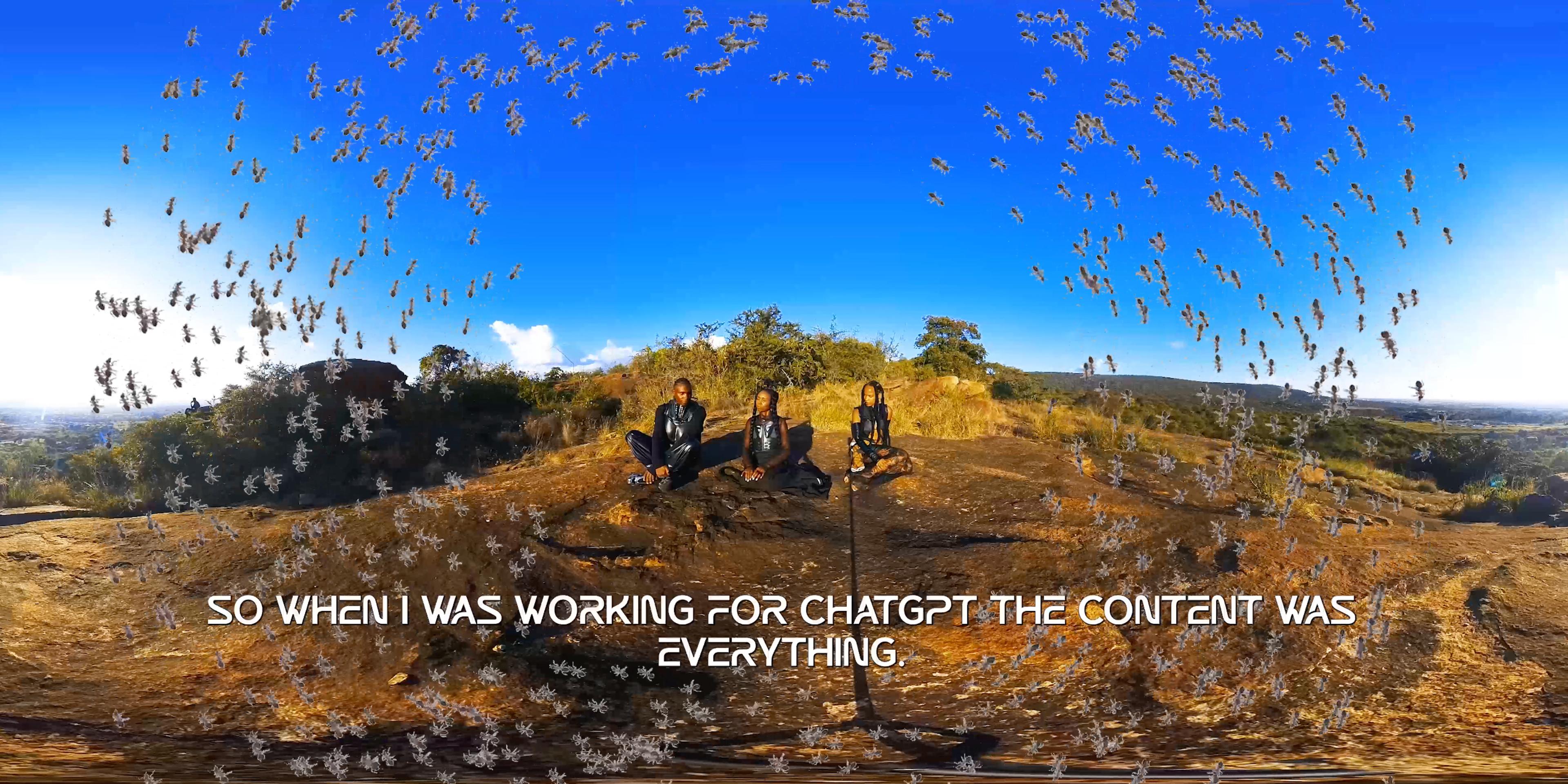 Video Still depicting a hill with 3 people sitting on the soil