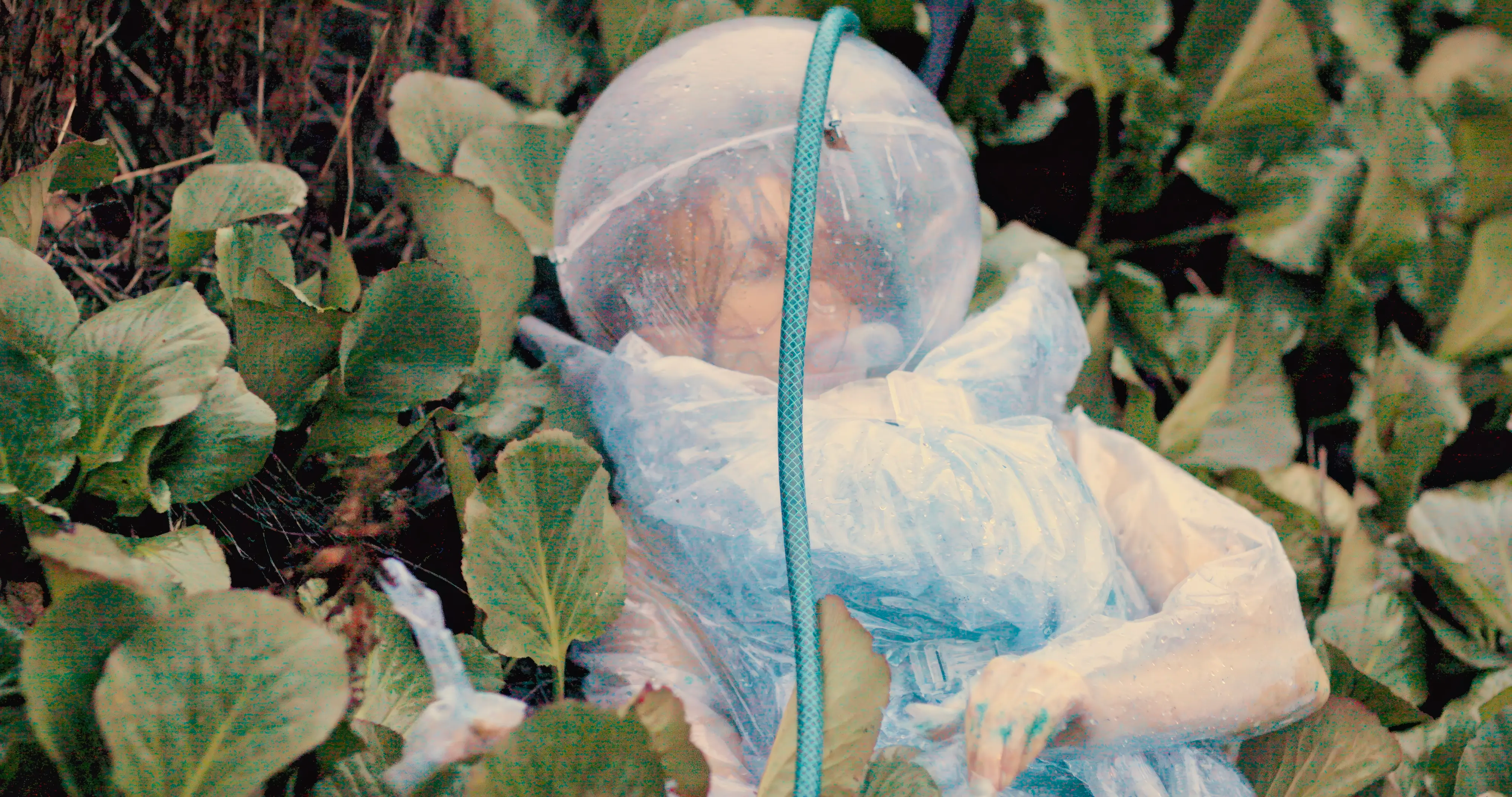 person laying down in grass in a water suit