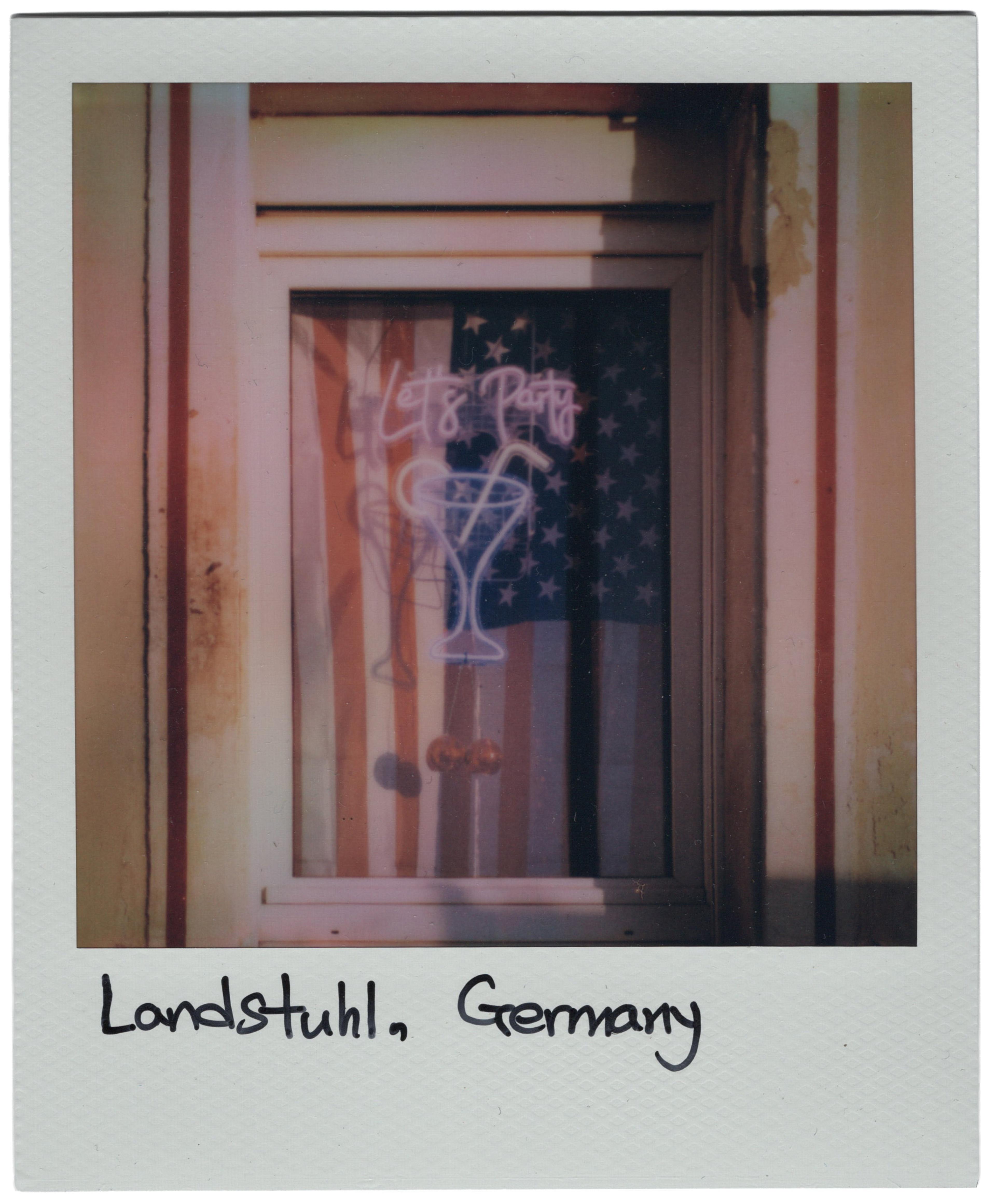 Image of a polaroid with neon sign and USA flag