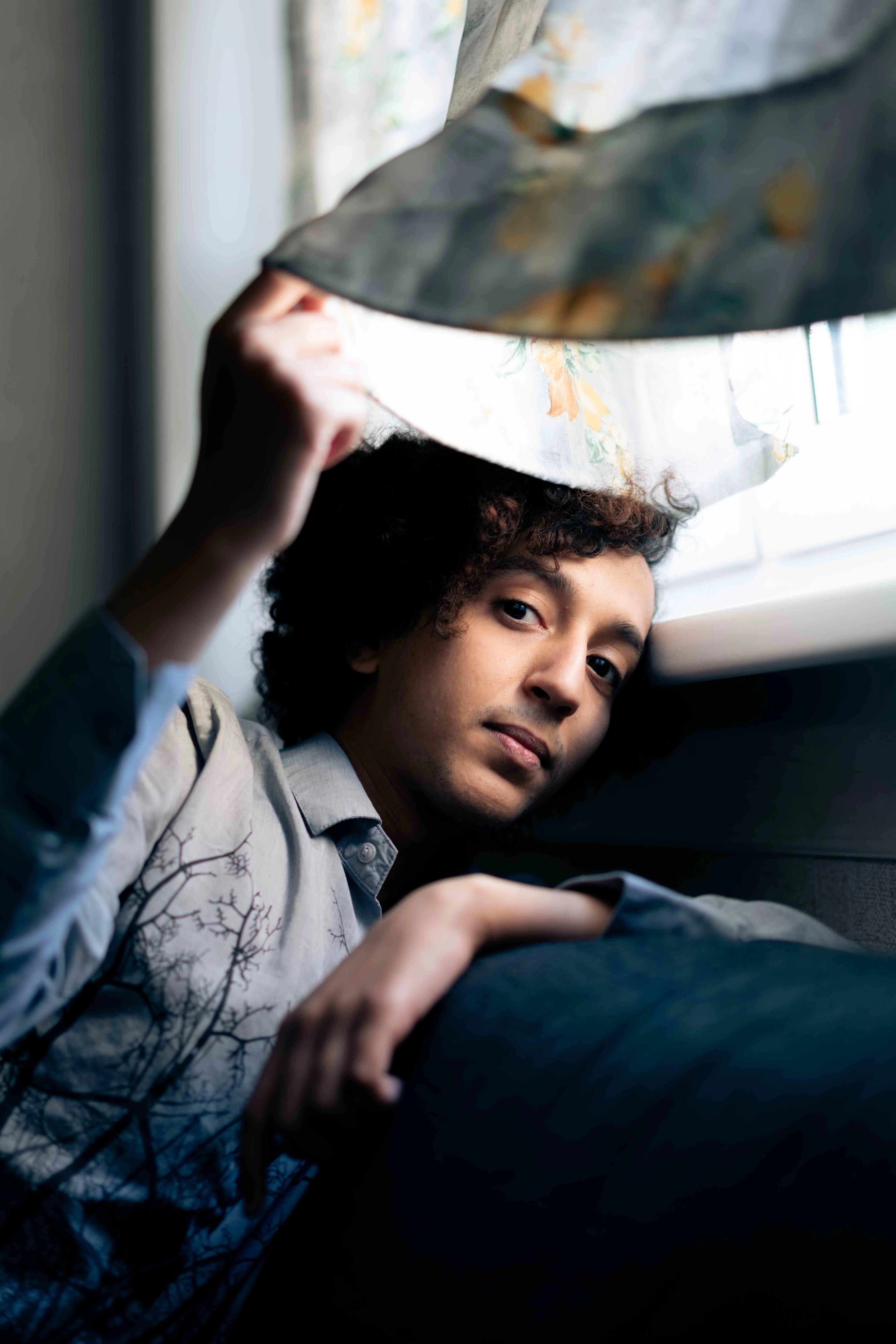 Portrait of a young man next to a window