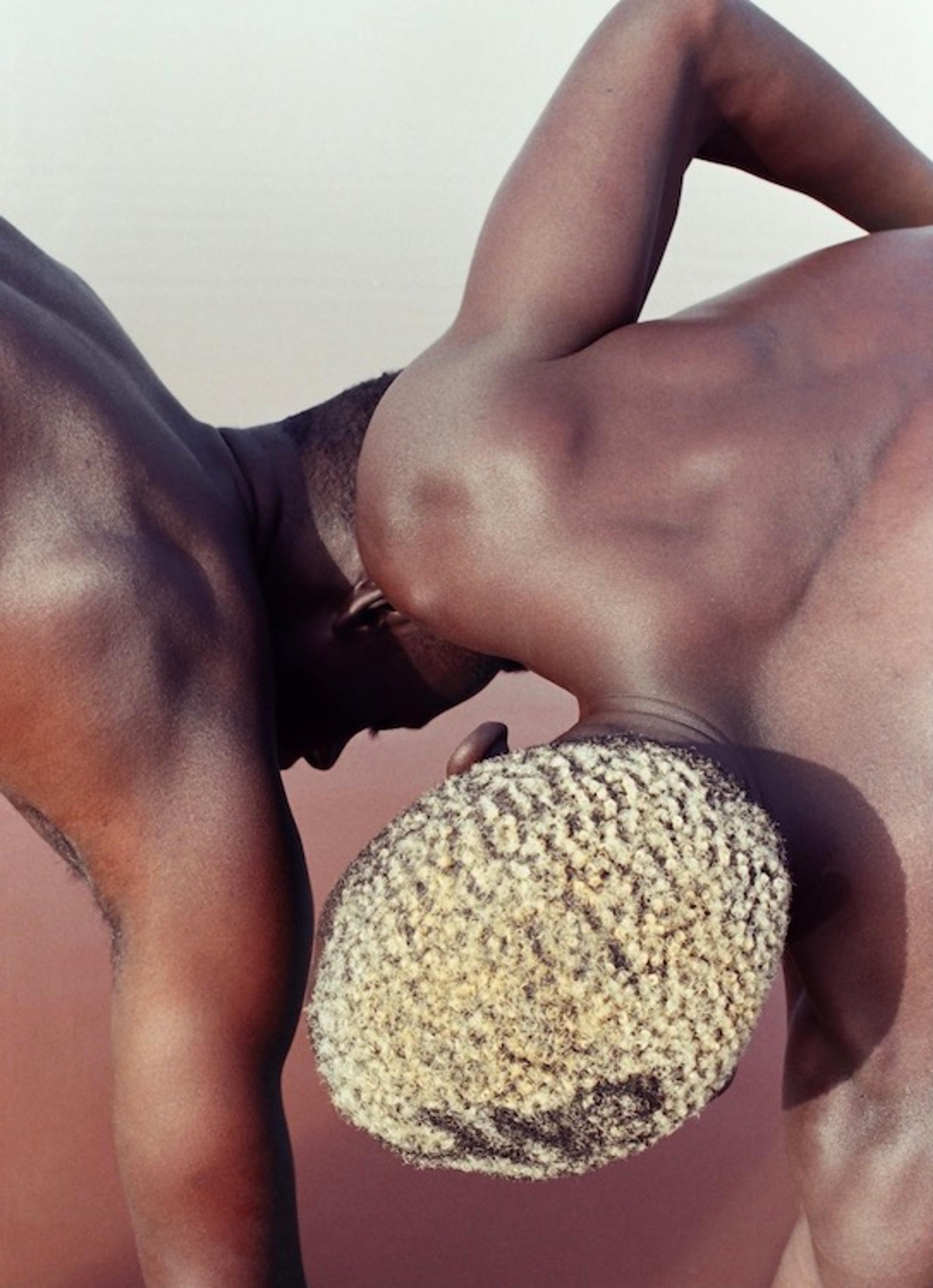 A geometric photograph of two men's heads and unclothed shoulders