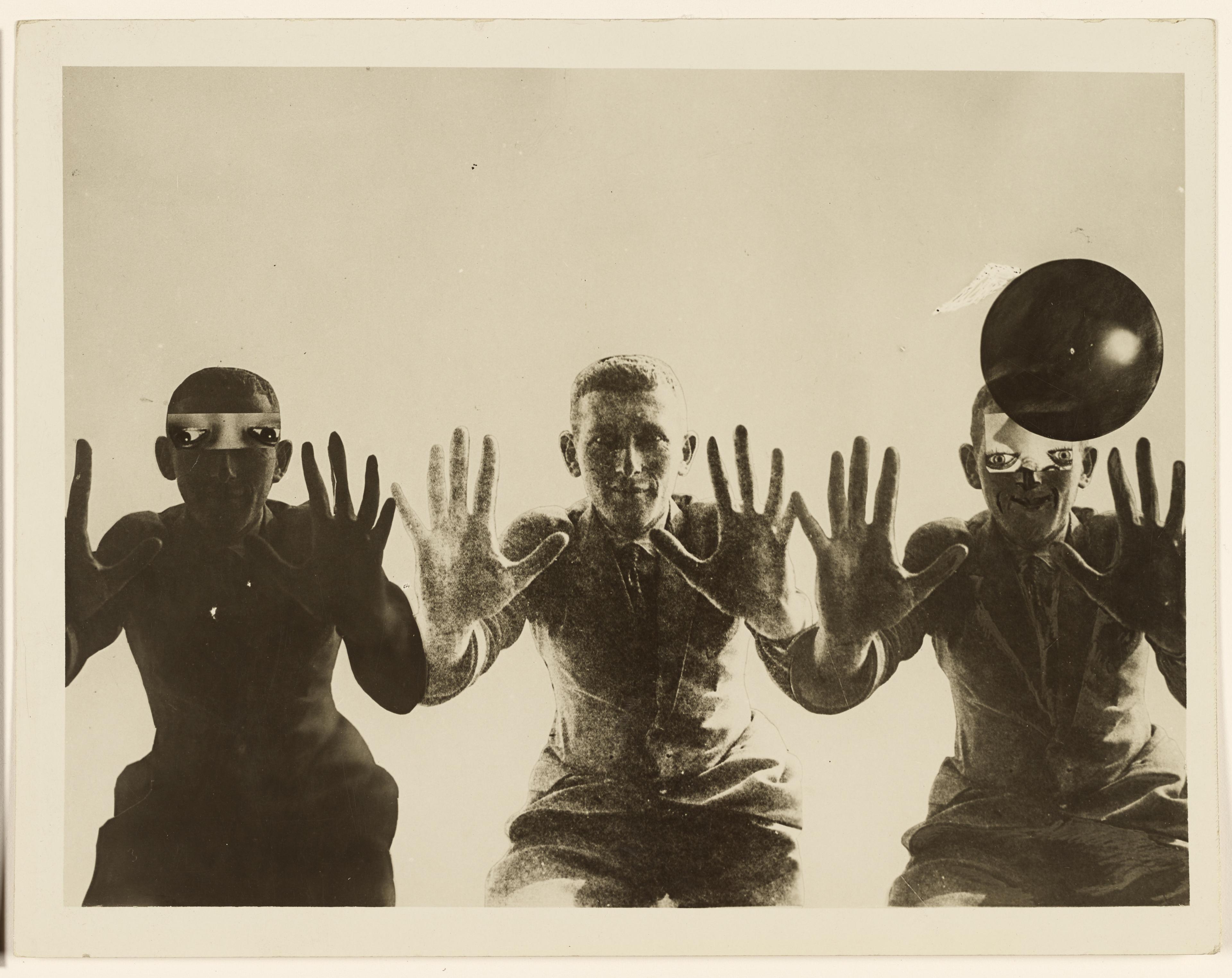 three men showing hands, sepia photograph