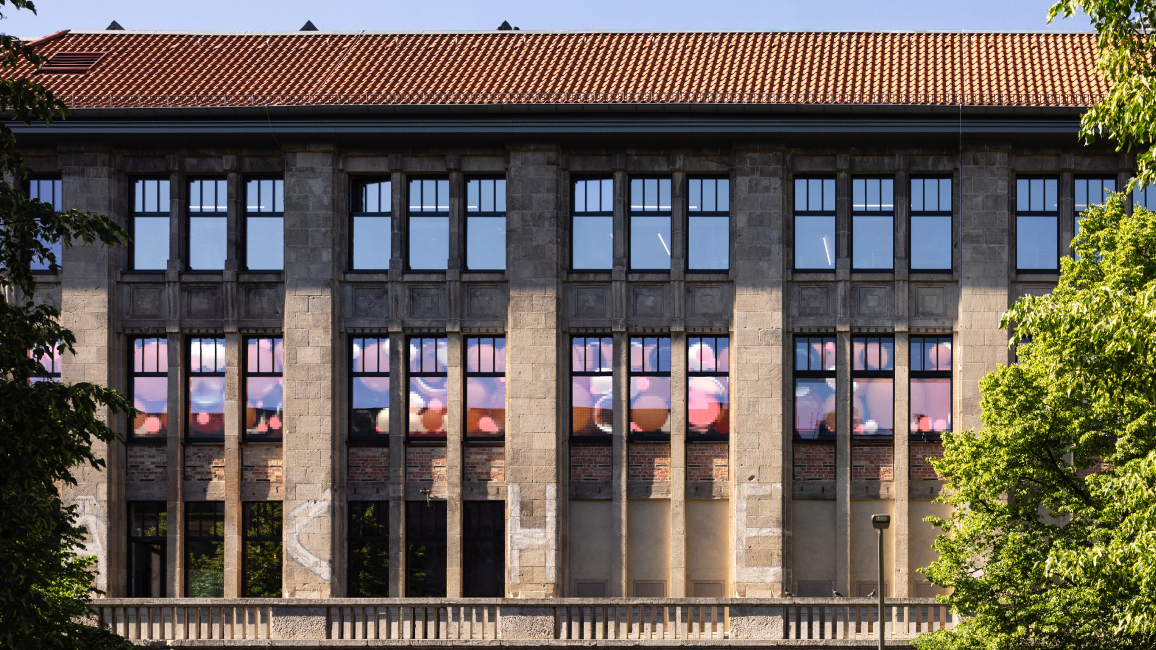 Facade of an old building with led panels behind glass showing an animation