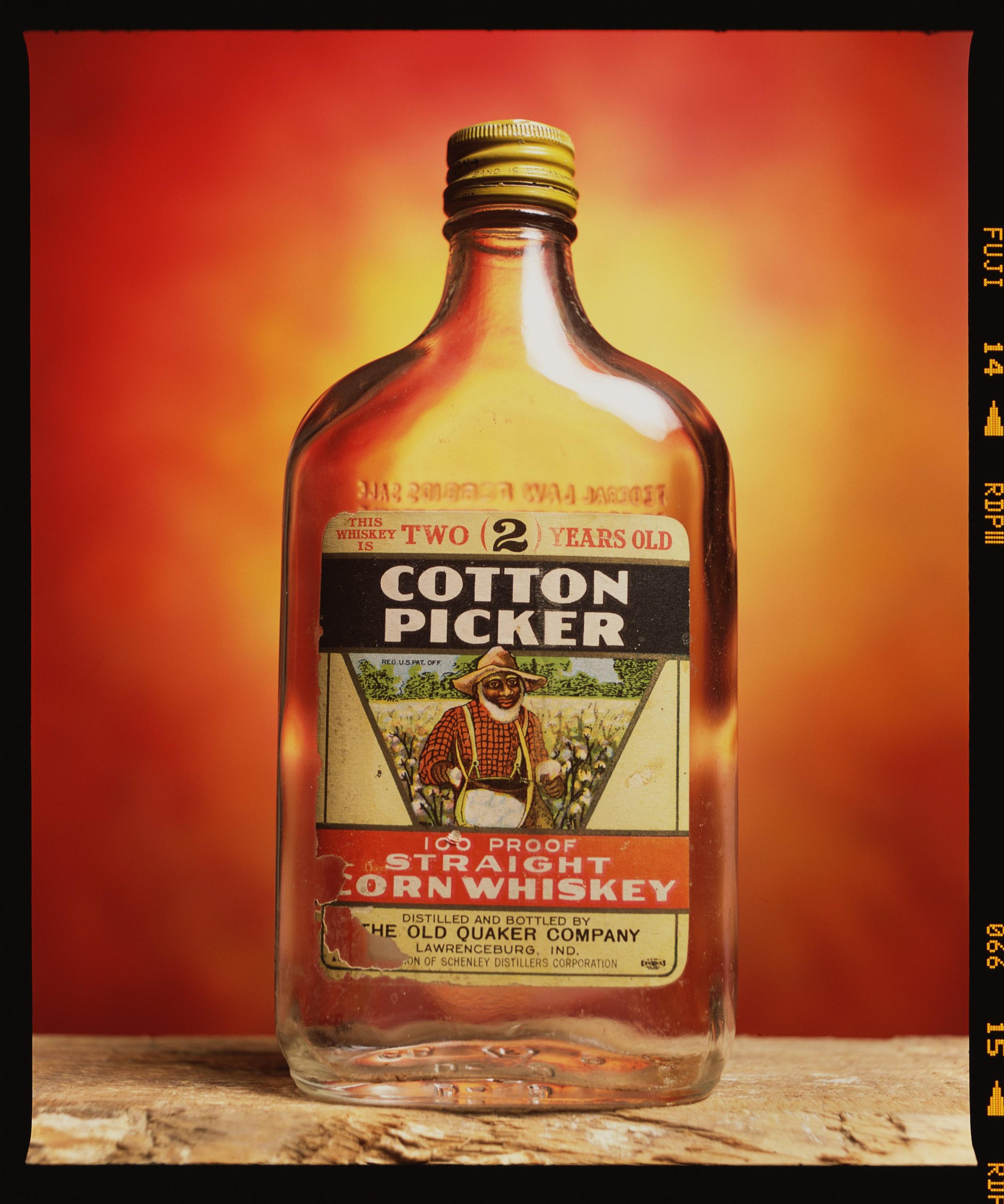 A vintage photograph of a bottle of Cotton Picker Corn Whiskey