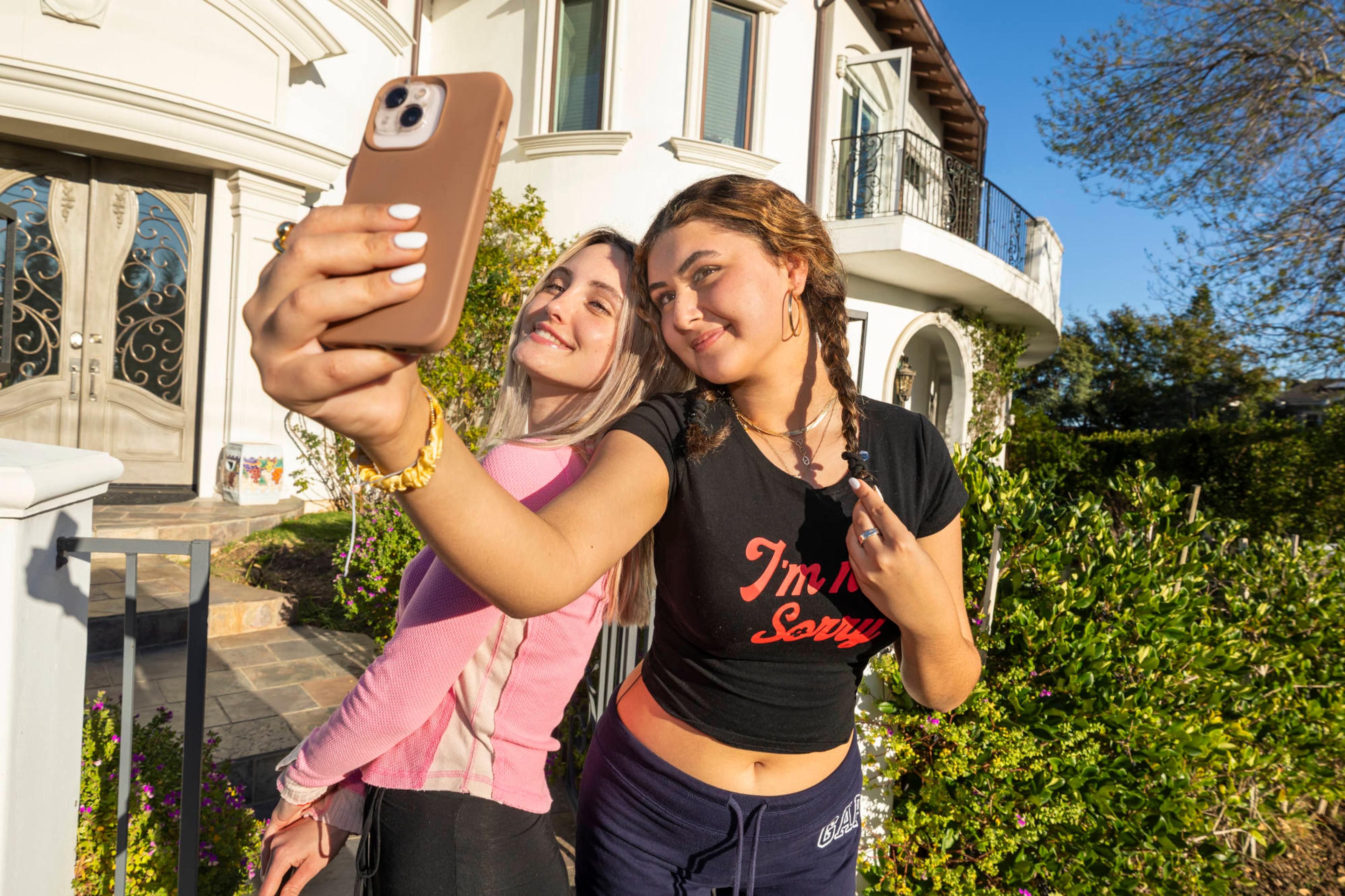 Image of a man and a women in bra and short skirt kissing while taking a selfie