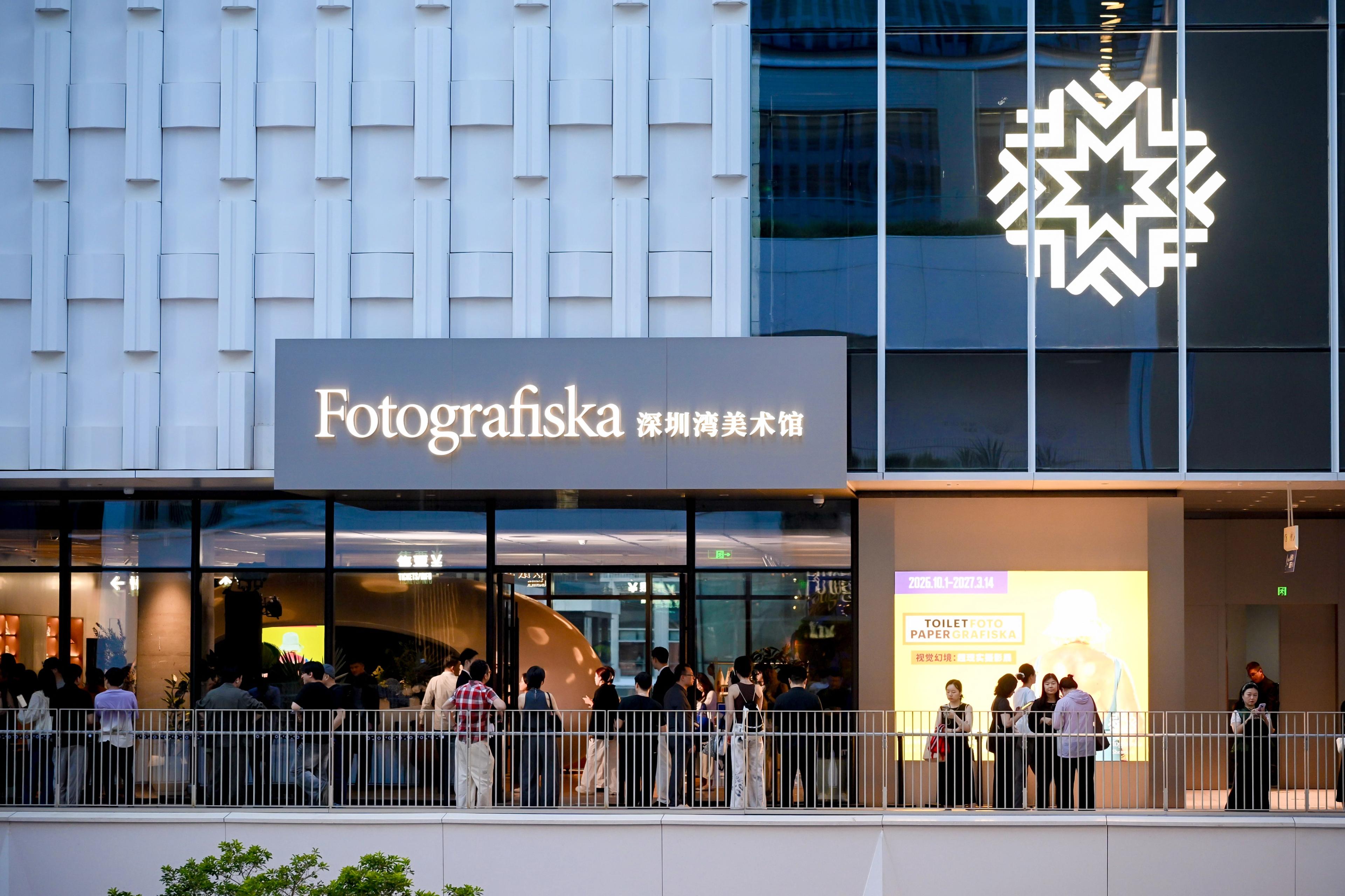 Building in Shenzhen, white facade, Fotografiska logo and signage, people in front