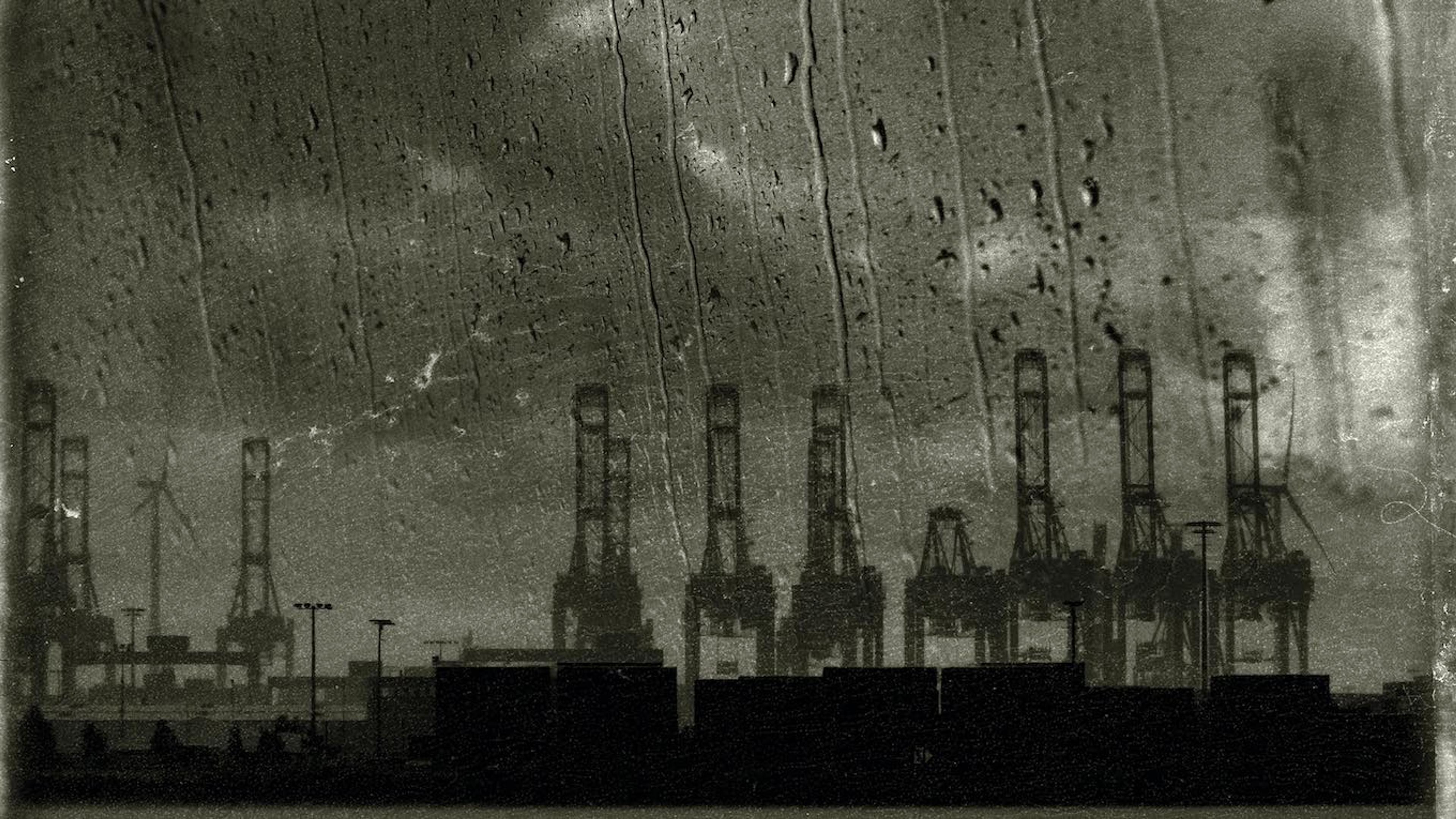 A dark photograph of an electrical plant during a storm