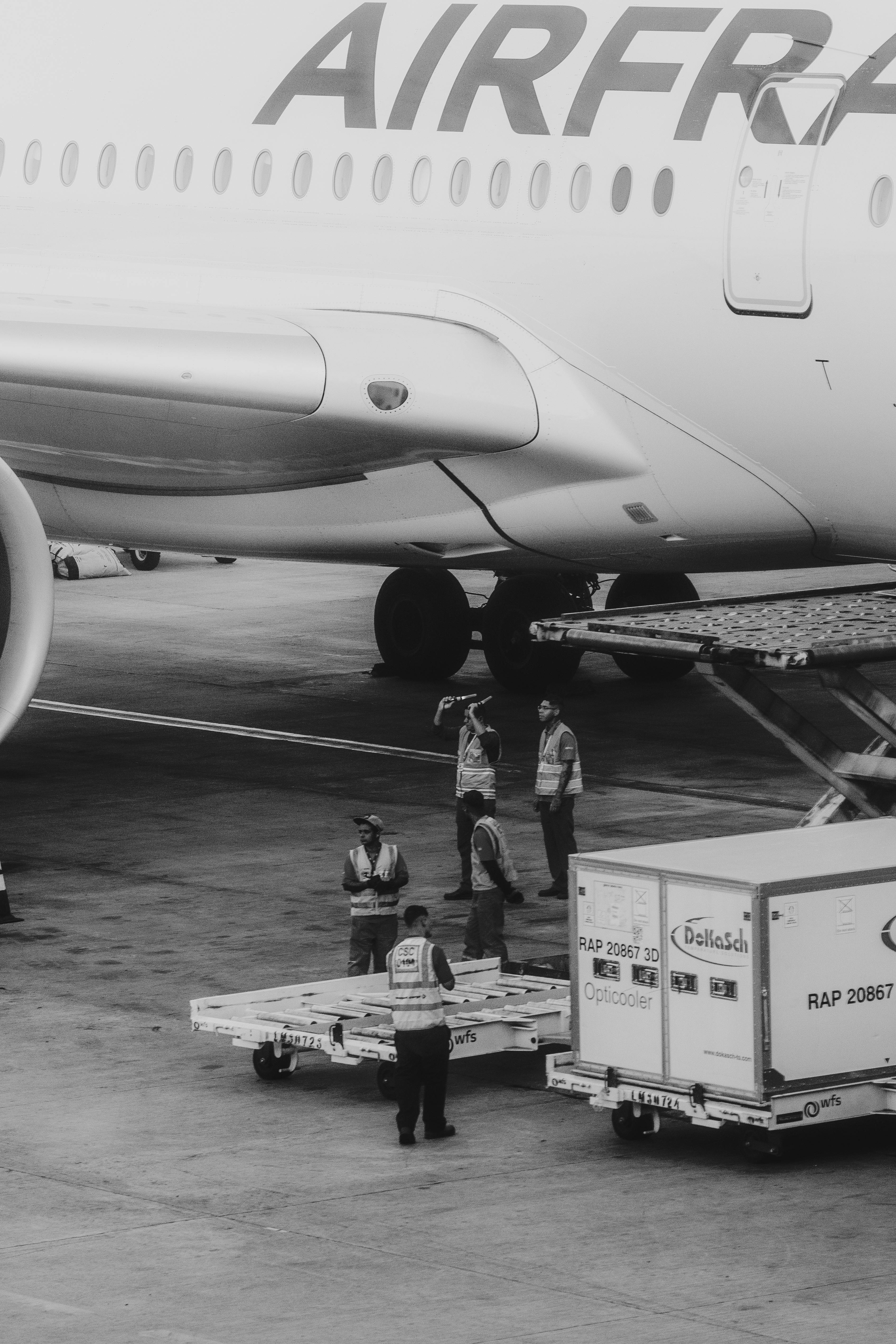 Black and White Airport Ground Crew Loading Luggage