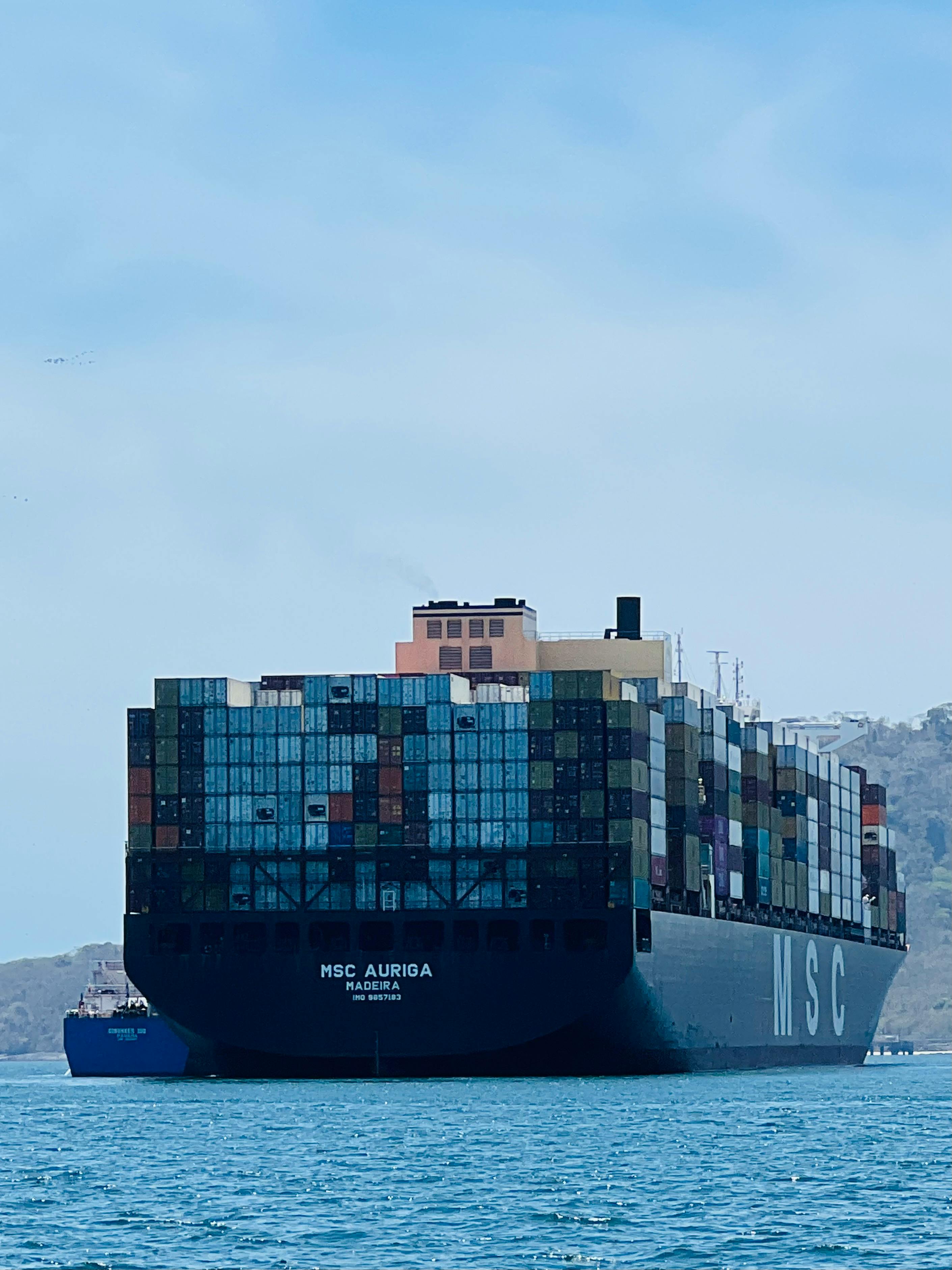 A large container ship is traveling on the water