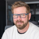 Bearded MSW student in blue glasses