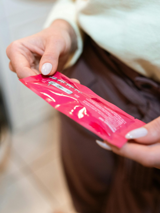 Woman's hands holding a packet of fertility tests