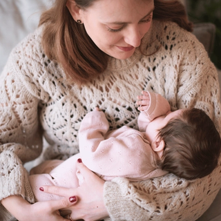 Mum holding sleeping newborn baby