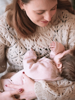 Mum holding sleeping newborn baby