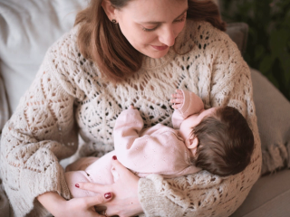 Mum holding sleeping newborn baby