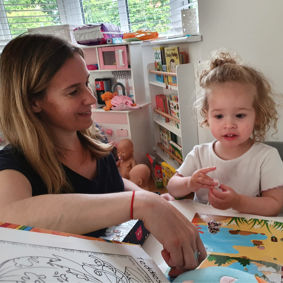 Helen with her little girl reading a book
