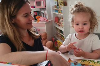 Helen with her little girl reading a book