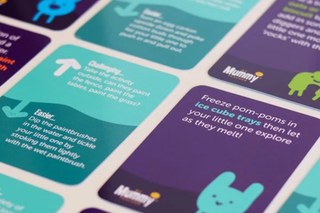 Play activity cards laid next to each other across a table