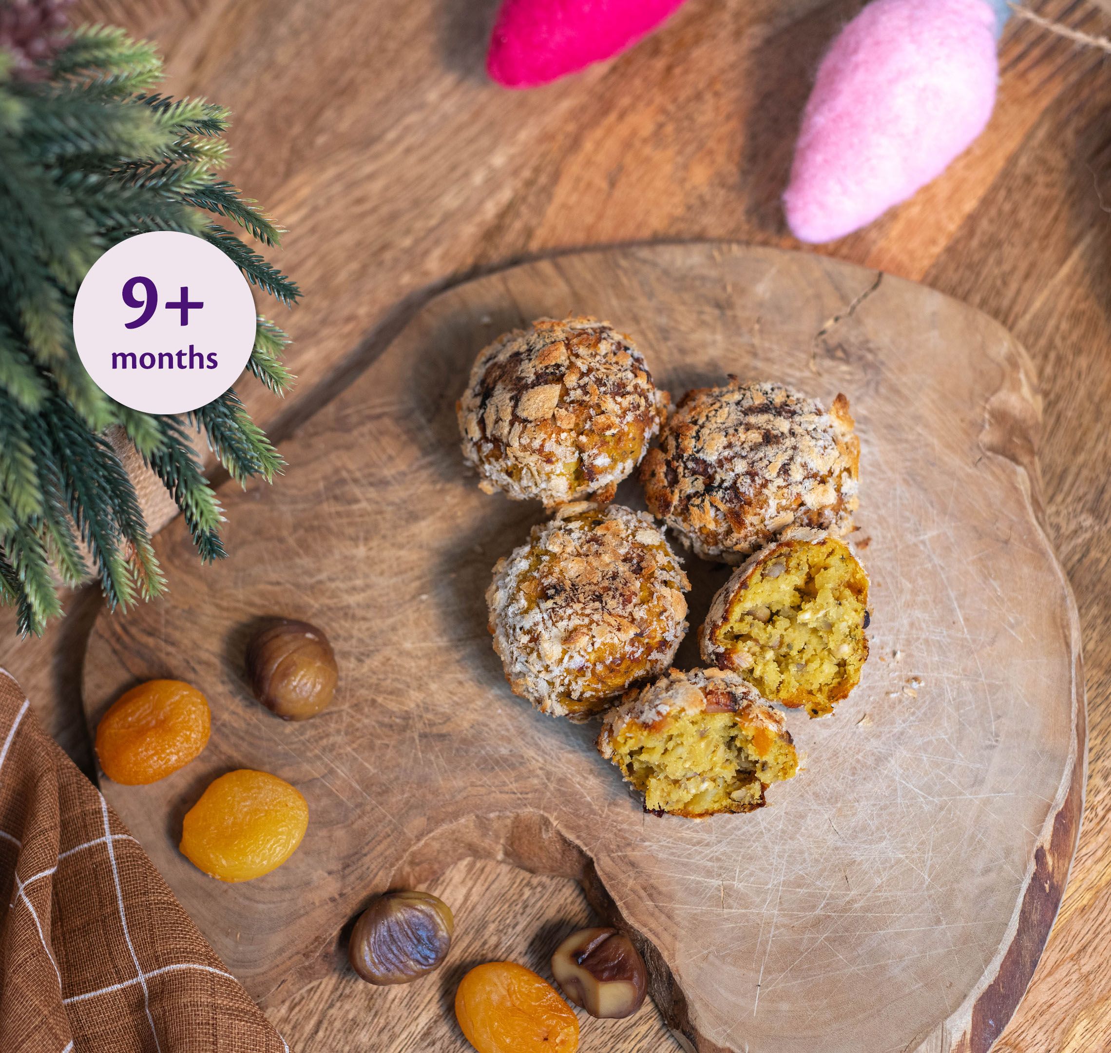 Festive Christmas bite-sized balls on a wooden board, suitable as a soft weaning snack for babies 9 months and over