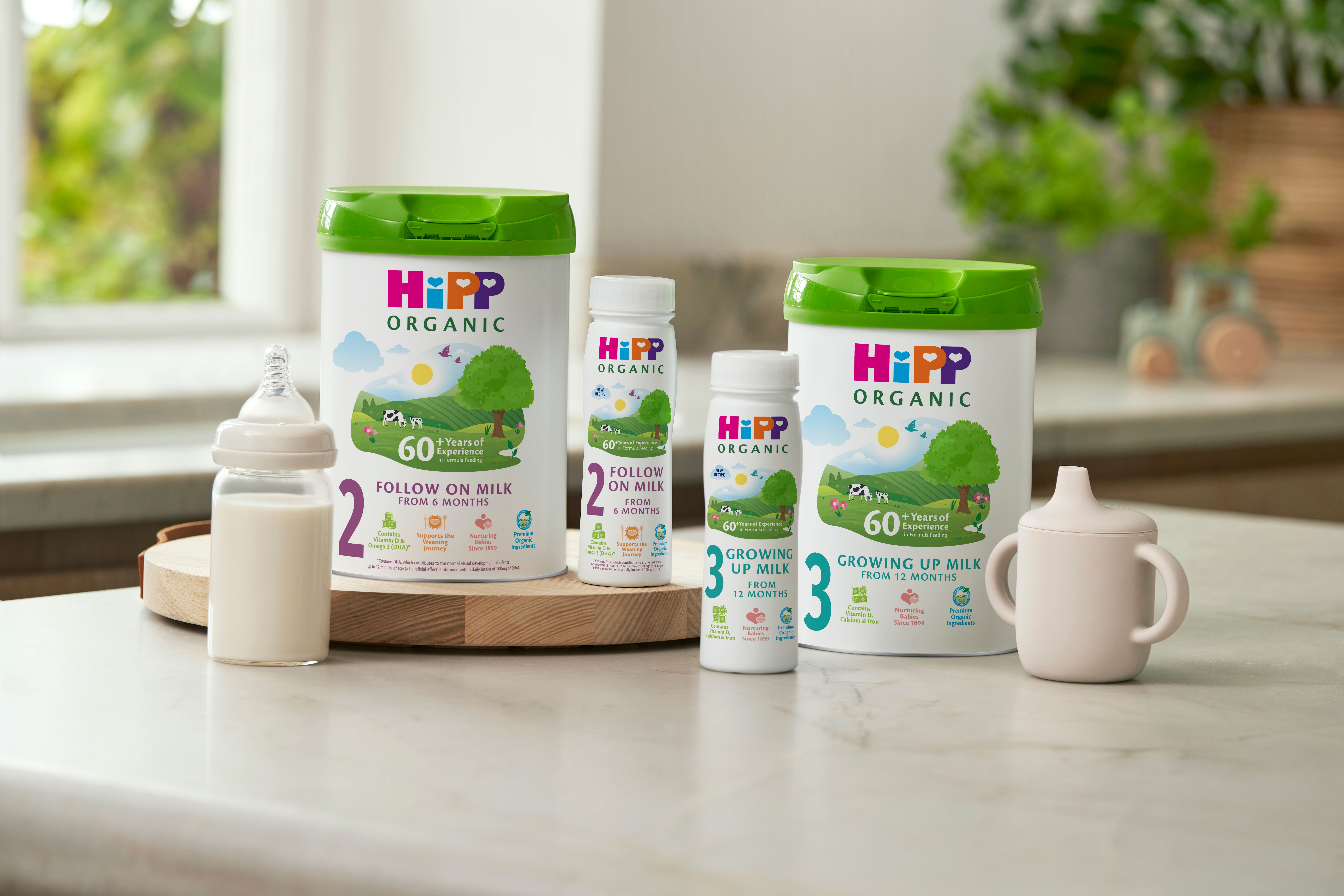 HiPP Organic follow on milks next to and on top of a delivery box outside the front door of a house