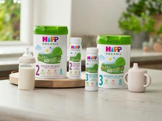 HiPP Organic follow on milks next to and on top of a delivery box outside the front door of a house