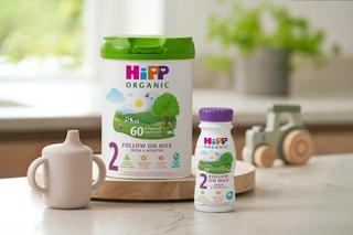 HiPP Organic follow on milks on a kitchen worktop next to a sippy cup