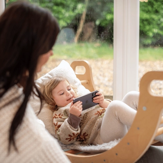 Toddler playing a game on phone
