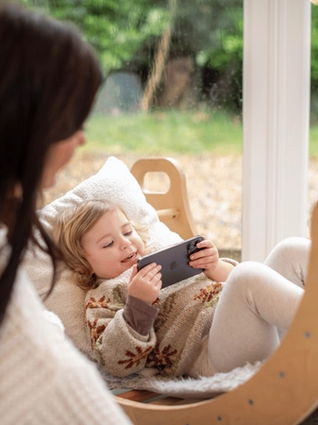 Toddler playing a game on phone