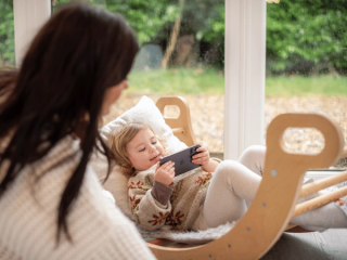 Toddler playing a game on phone